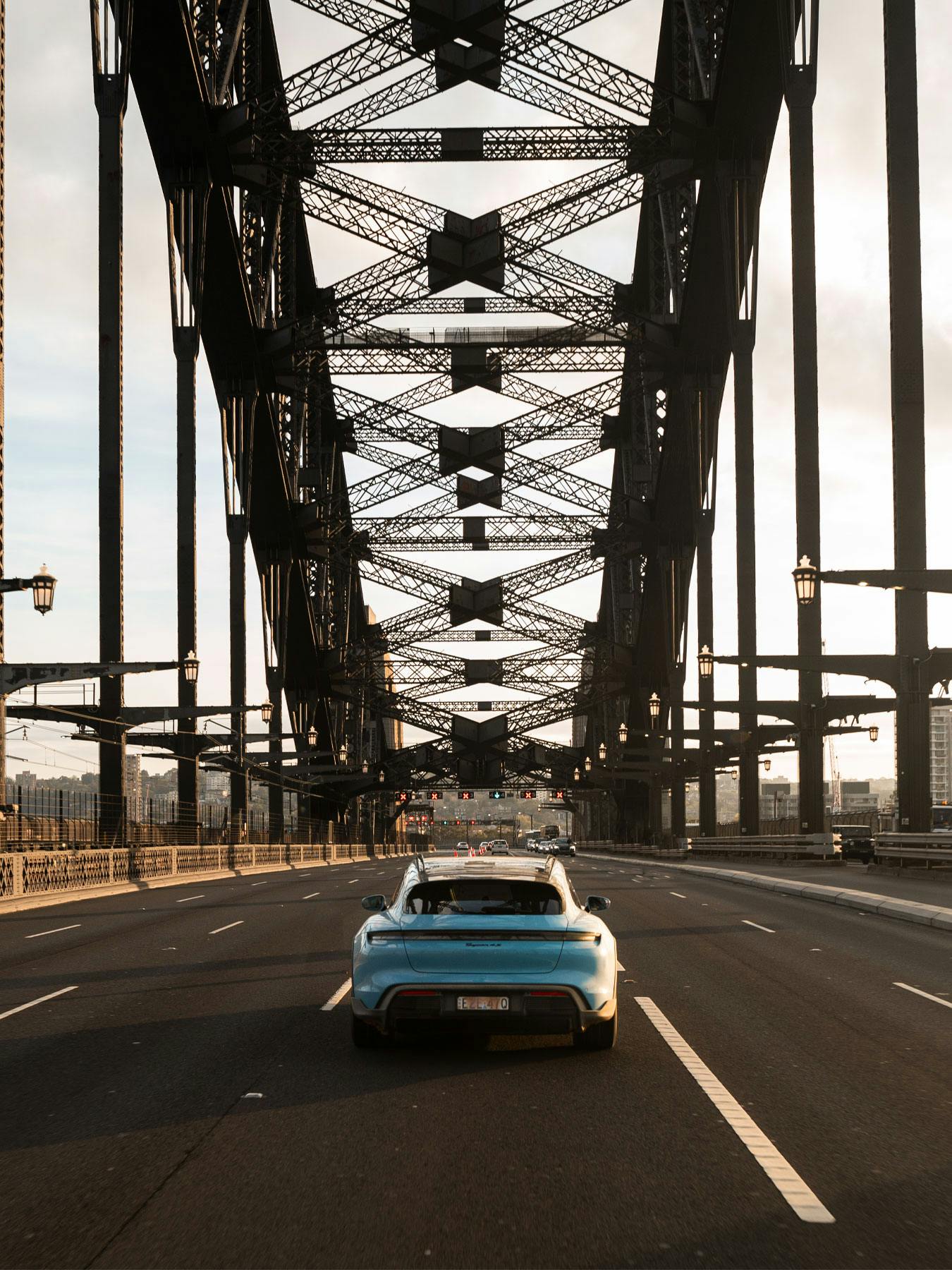 Porsche Taycan driving on the sydney harbour bridge