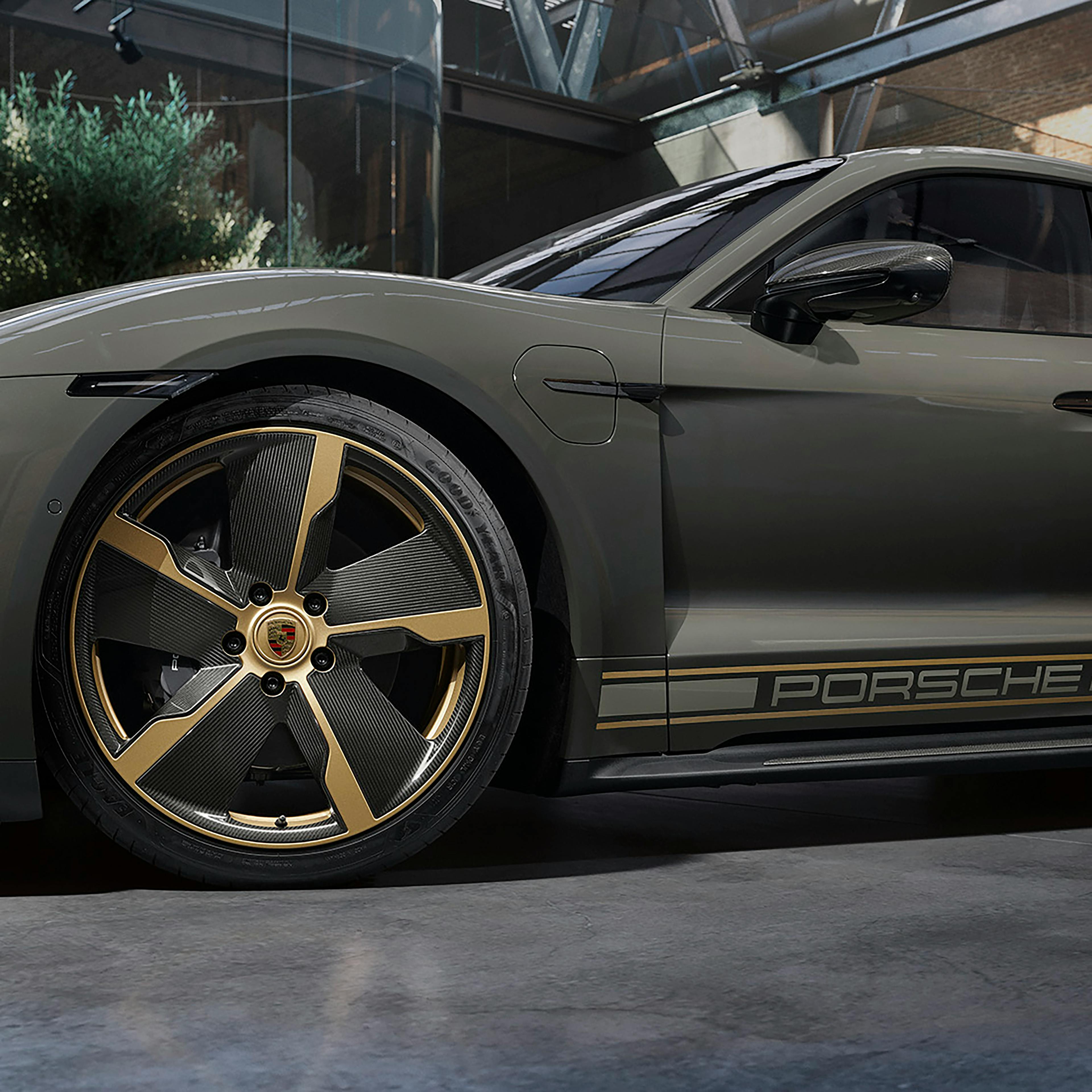 Side shot of a Sonderwunsch Taycan in Grey, close-up of the front wheel, rim with a striking shape and colour.