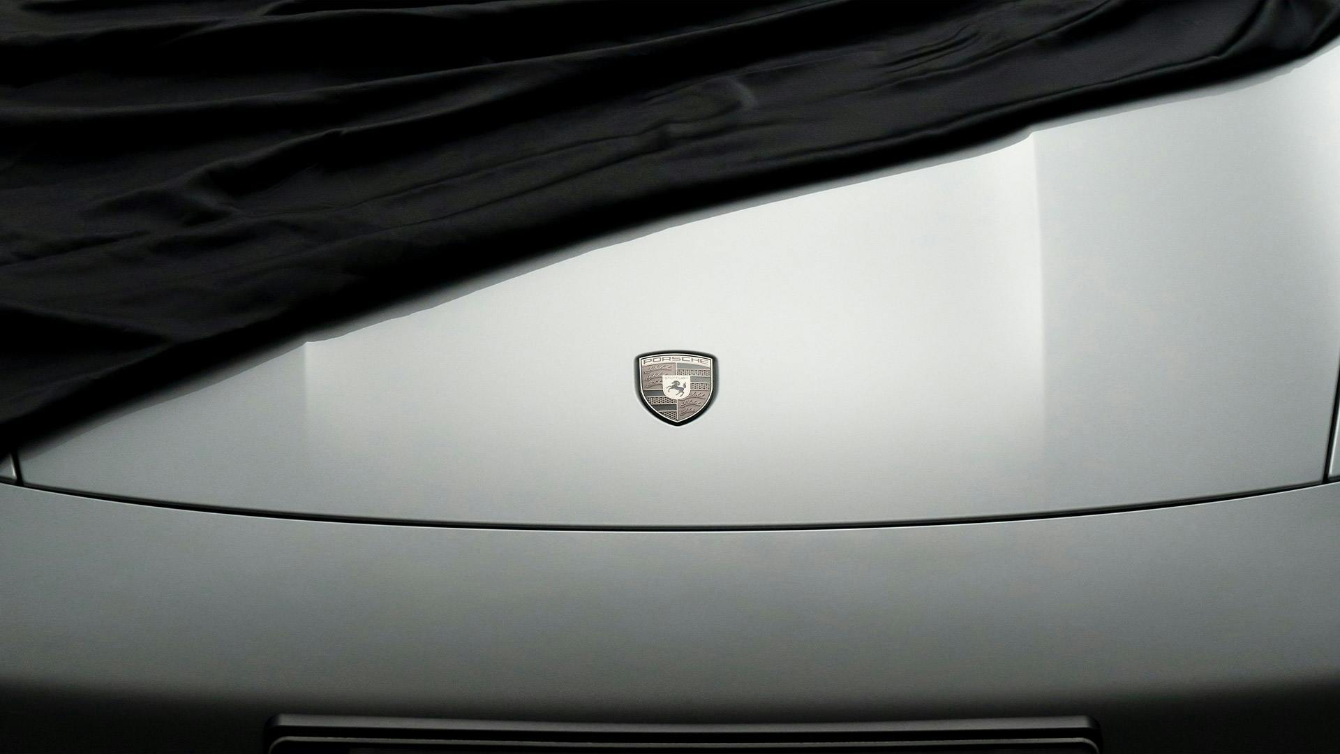 High-quality image of the Porsche emblem on a bonnet.