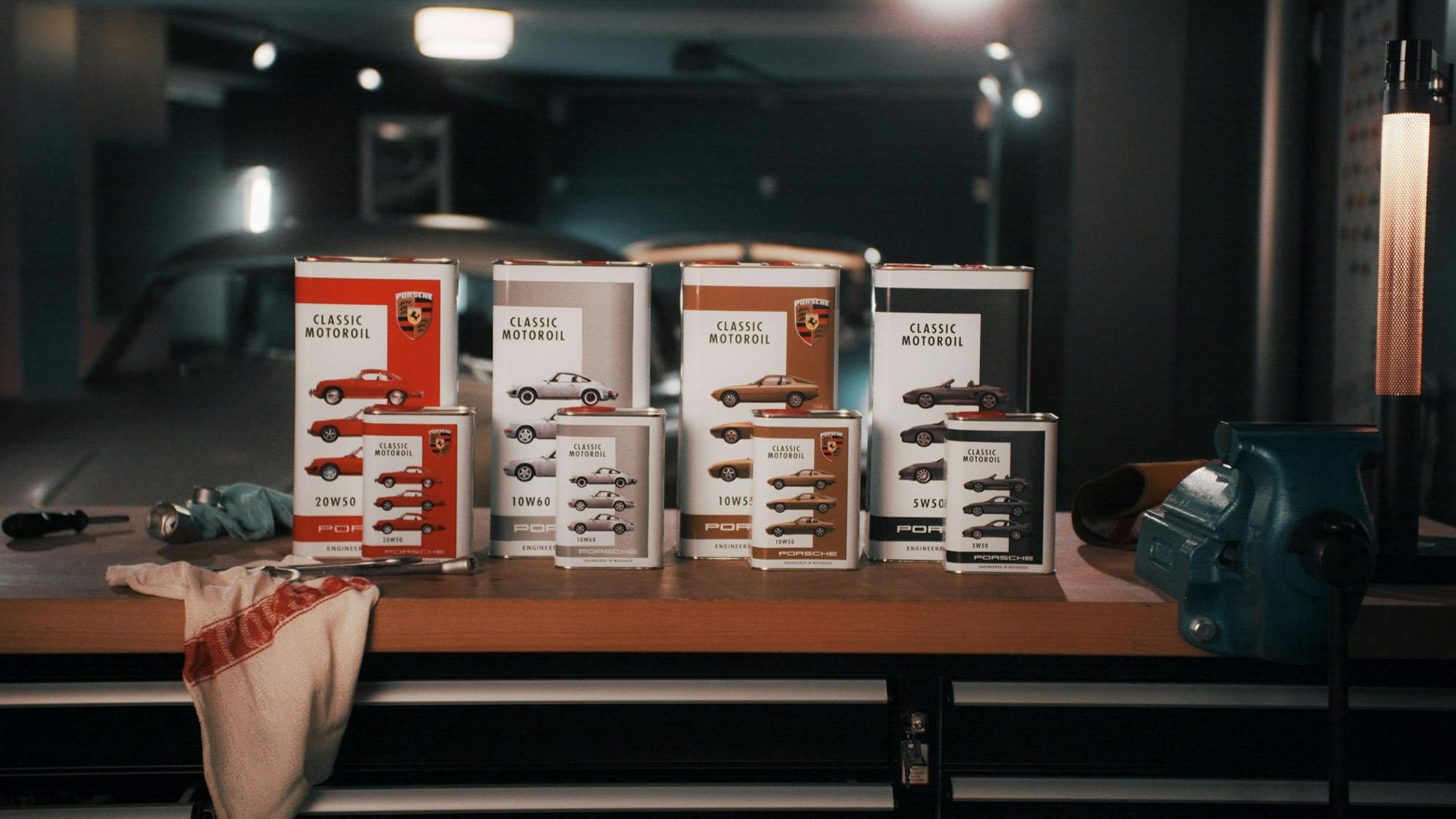 Four canisters of Classic engine oil on a workbench. A Classic model can be seen in the background.