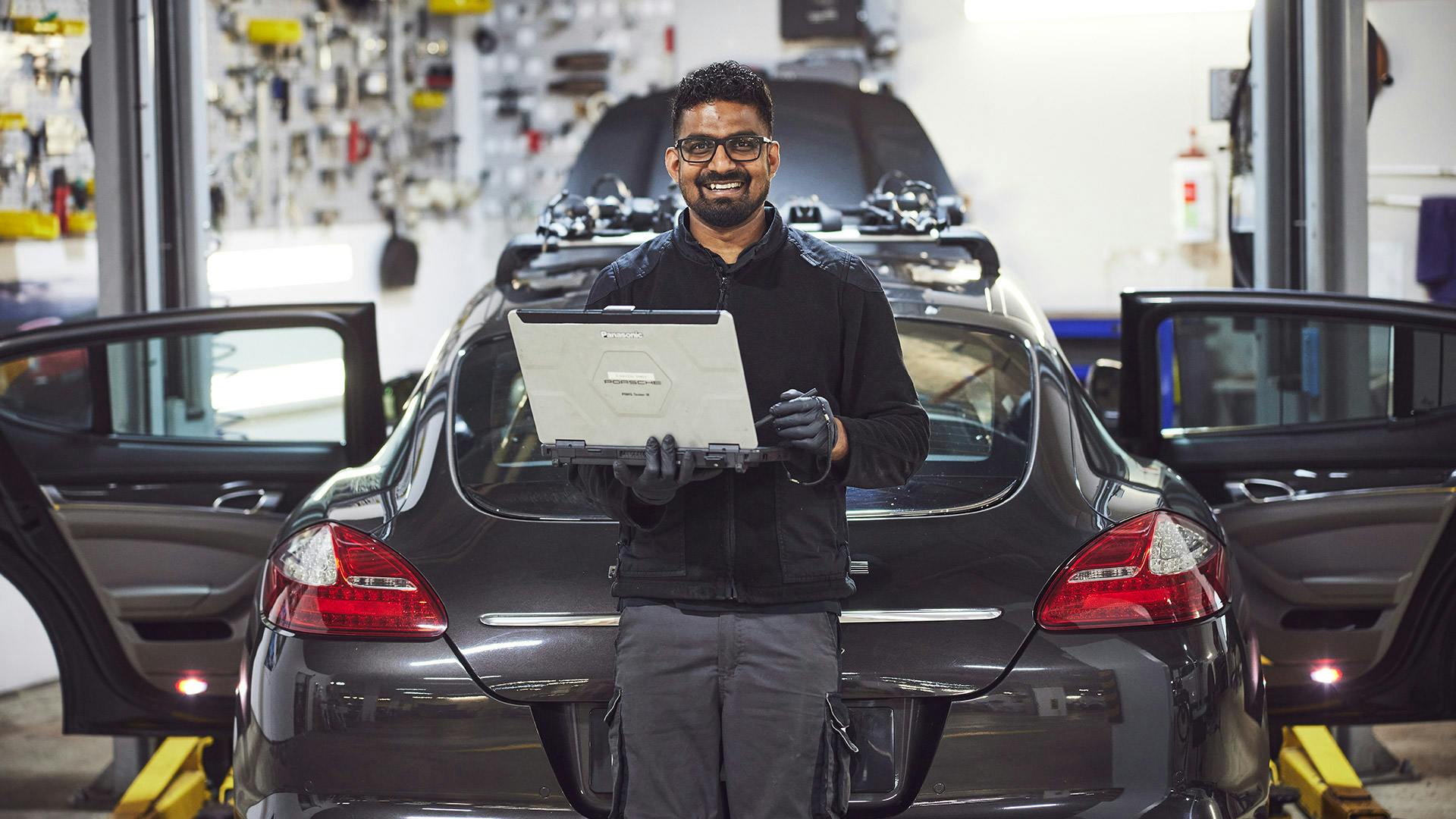 Porsche technician diagnosing vehicle
