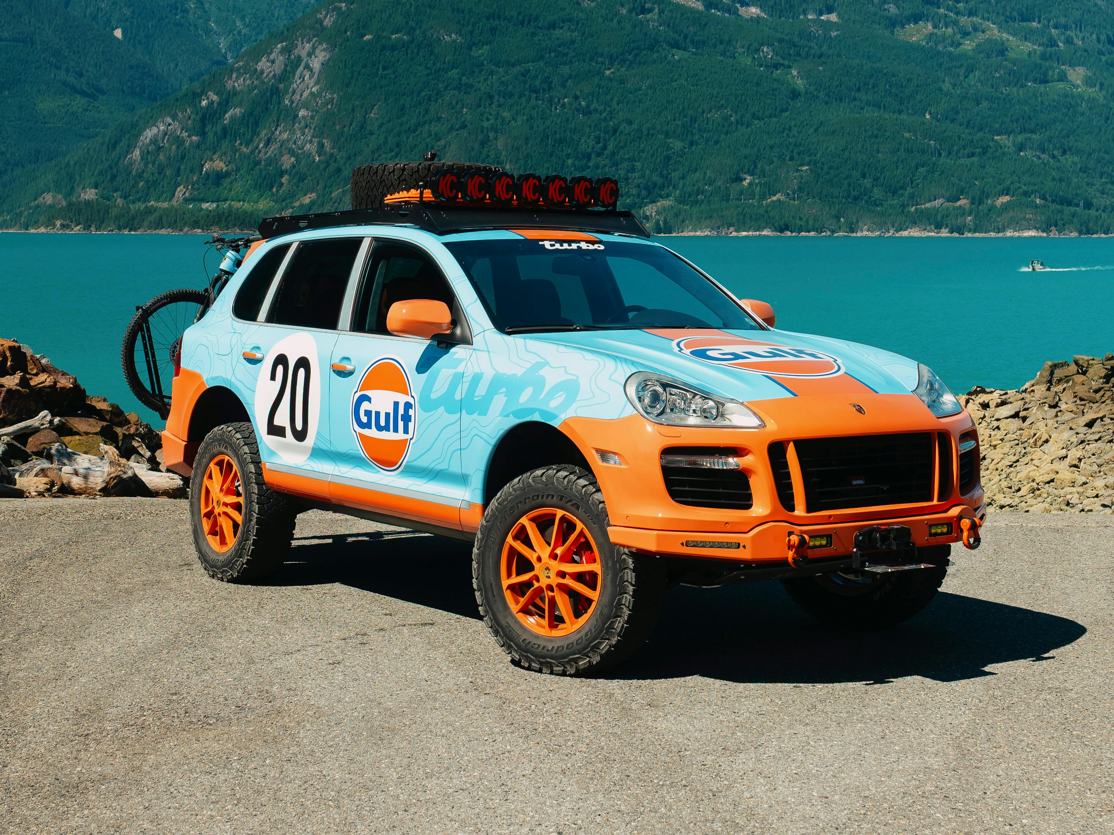 Vancouver – A white Porsche Cayenne pictured off-road, navigating snowy and rocky terrain.