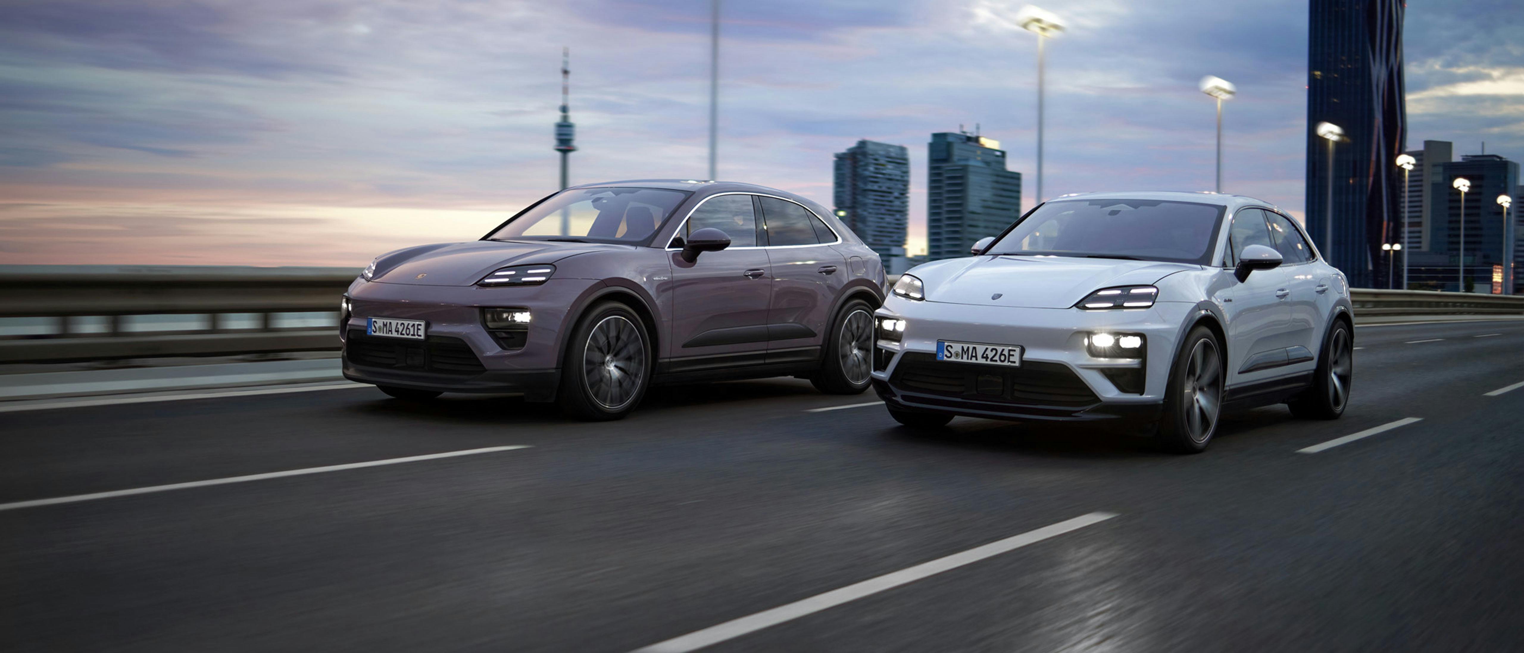 Provence Macan and white Macan driving on a highway at dusk.