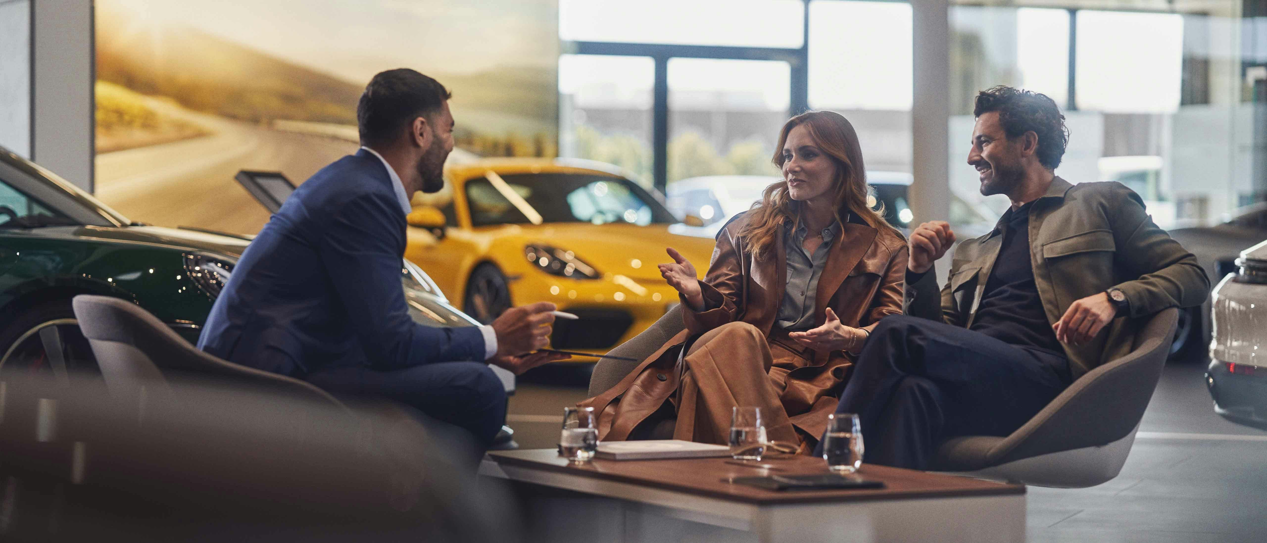 Två personer på rådgivning hos ett Porsche Center.