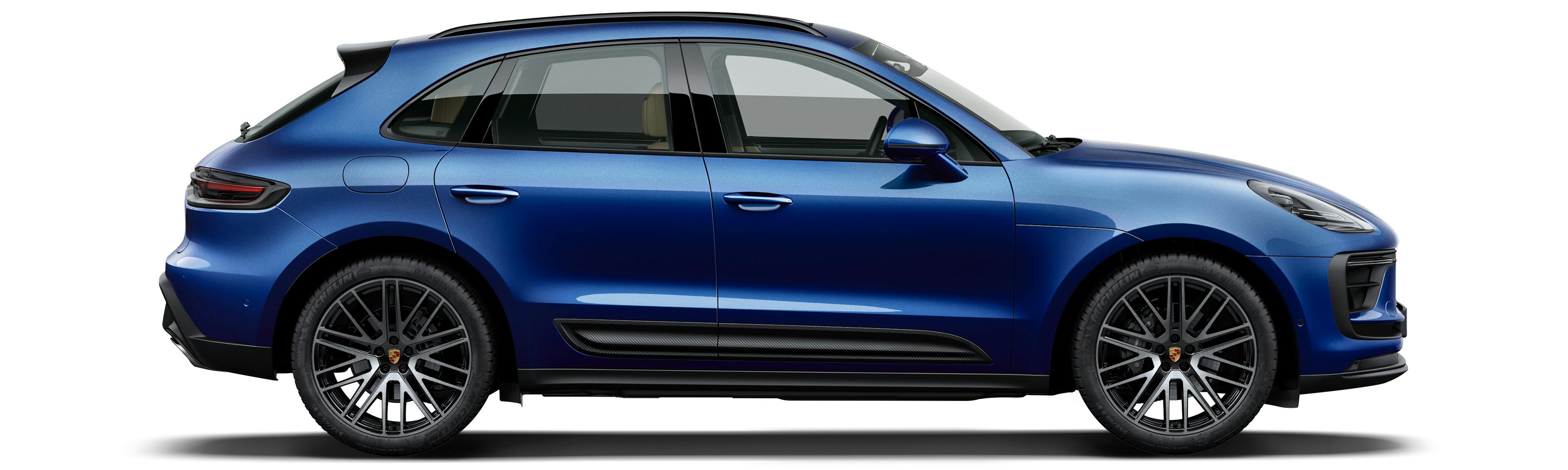 Side shot of a blue metallic Porsche Macan on a white background.