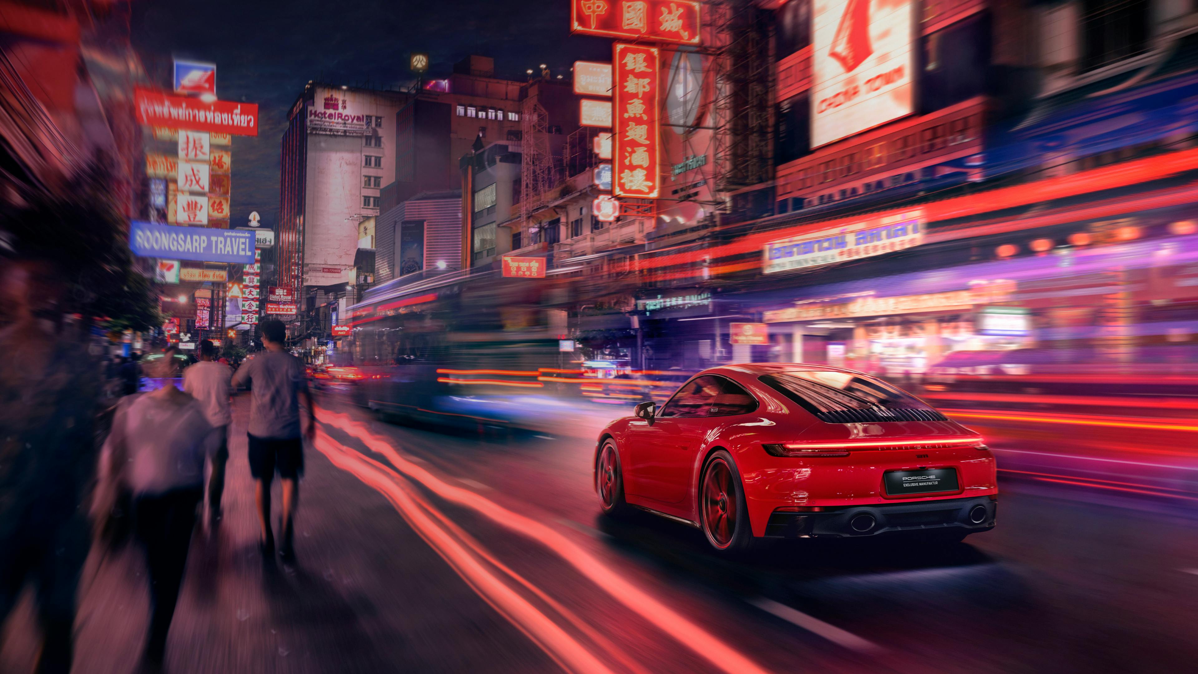 Dreams in Colours: Red 911 model drives through Thailand city at night.