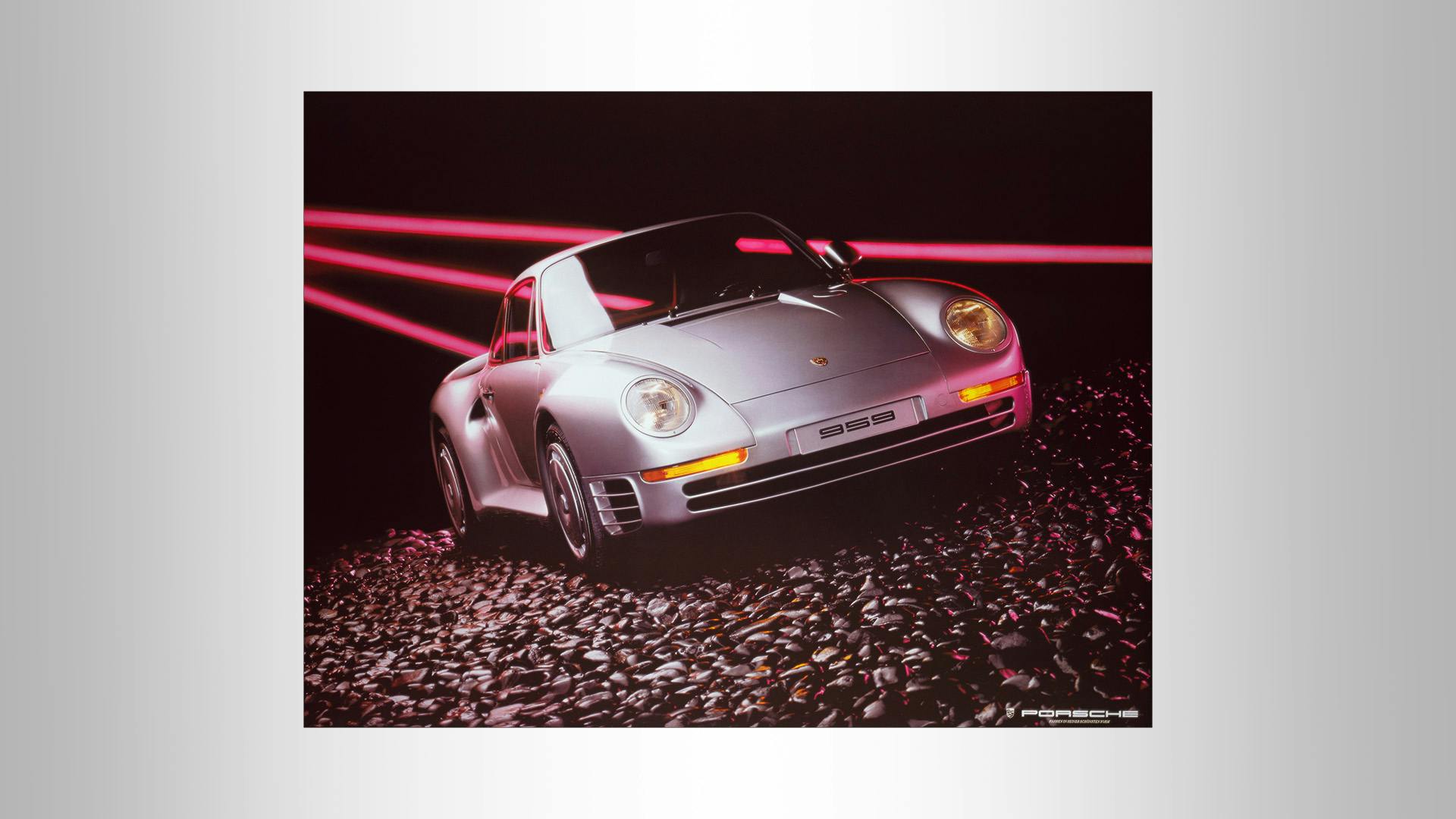 Advertising poster with a silver Porsche 959 on a black background with red lights.