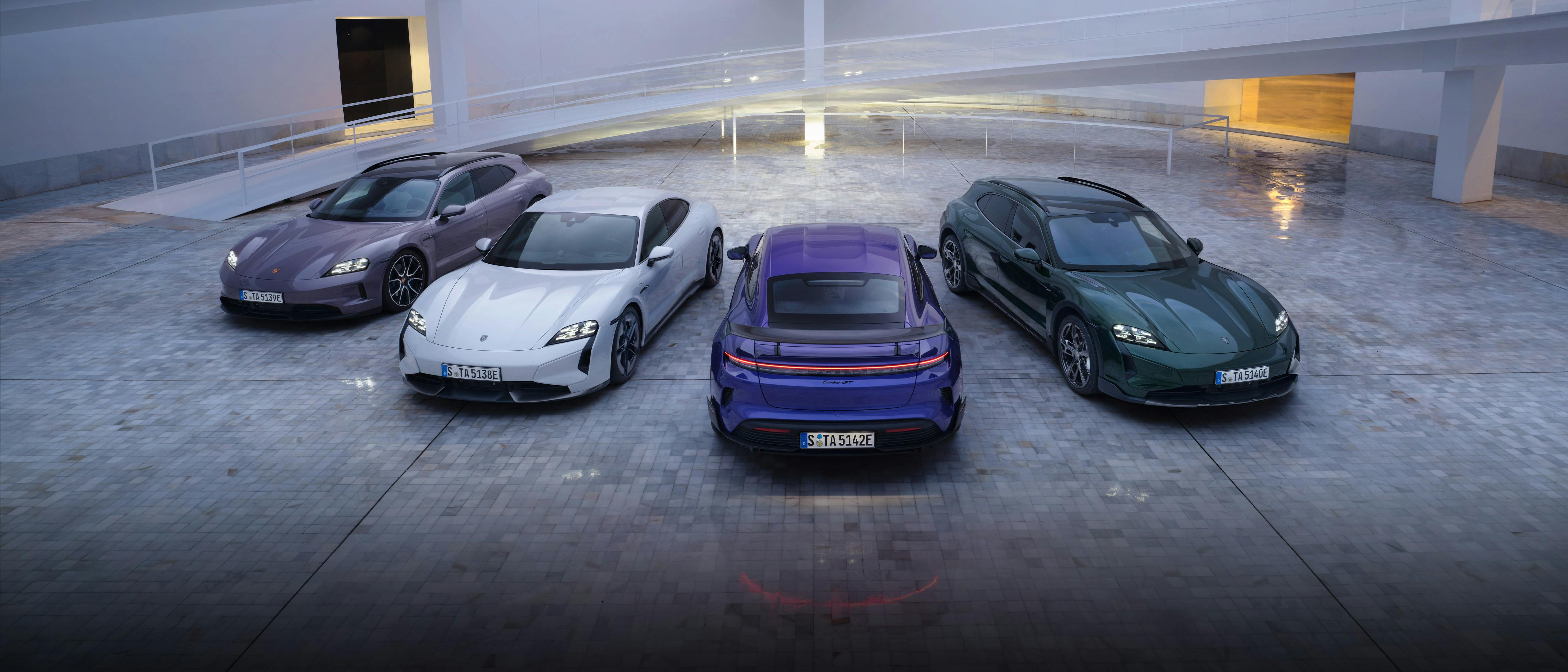The Taycan, Taycan Cross Turismo, Taycan Sport Turismo and Taycan Turbo GT with Weissach Package parked in a modern building.