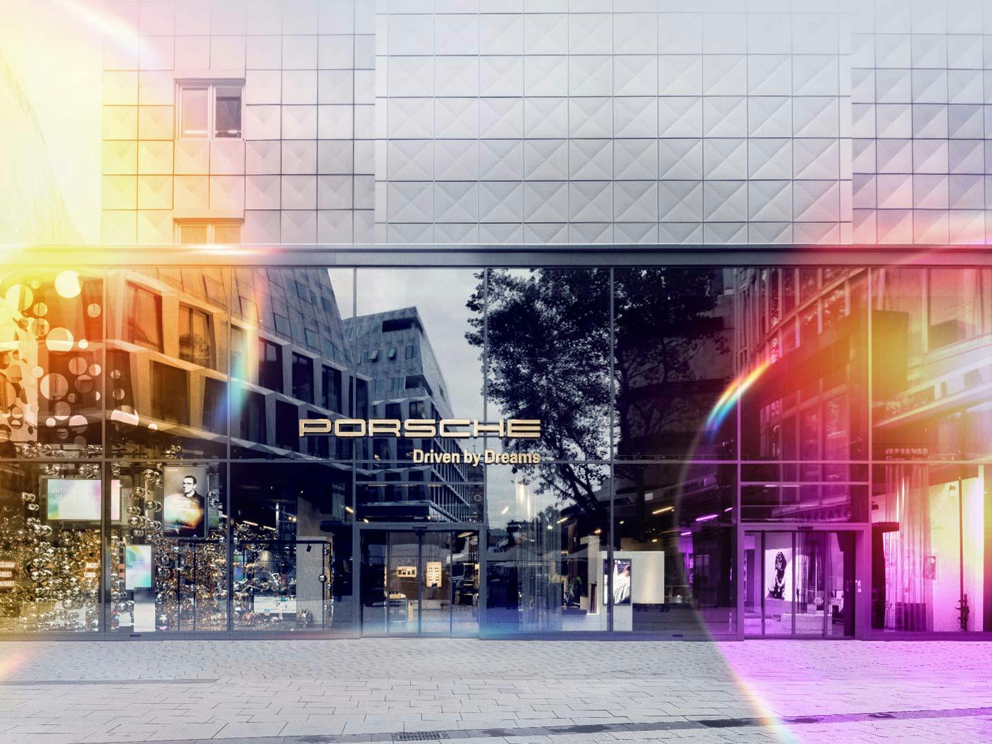 Foto der Gebäudefront des Porsche Brand Stores, stilisiert mit bunten Seifenblasen im Vordergrund.