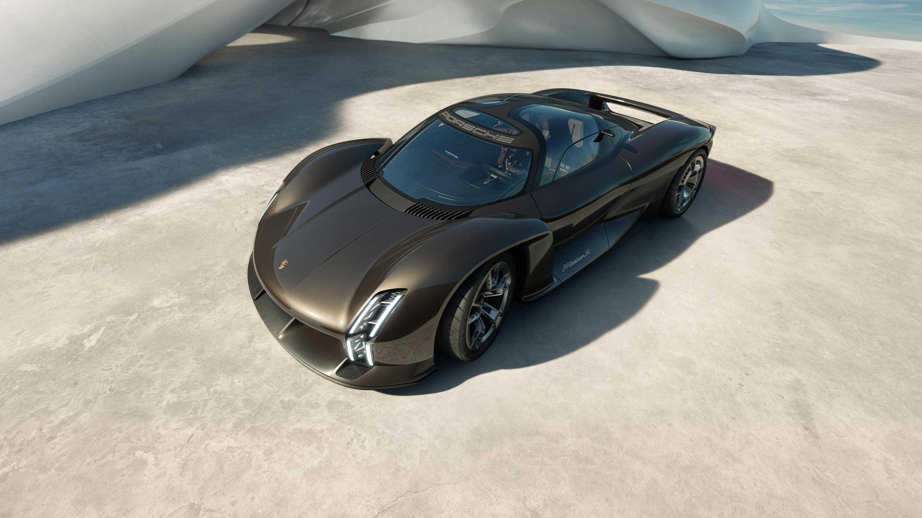 Porsche Mission X in Rocketmetallic staat voor golfachtige architectuur. Blik van boven op voorkant en zijkant.
