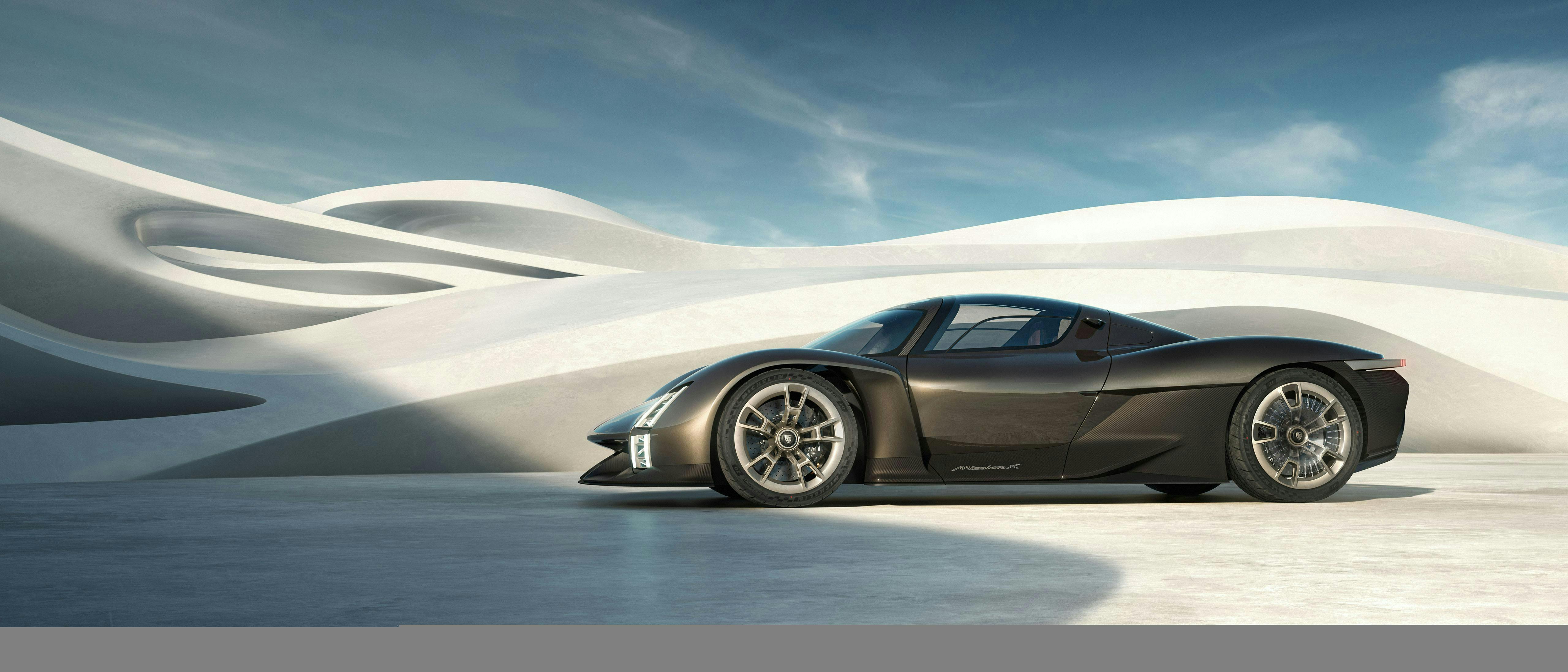波のような建築物の前に停まっているロケットメタリックのPorsche Mission X サイドから見た車両コンセプト、プロフィールが明確に表れています。