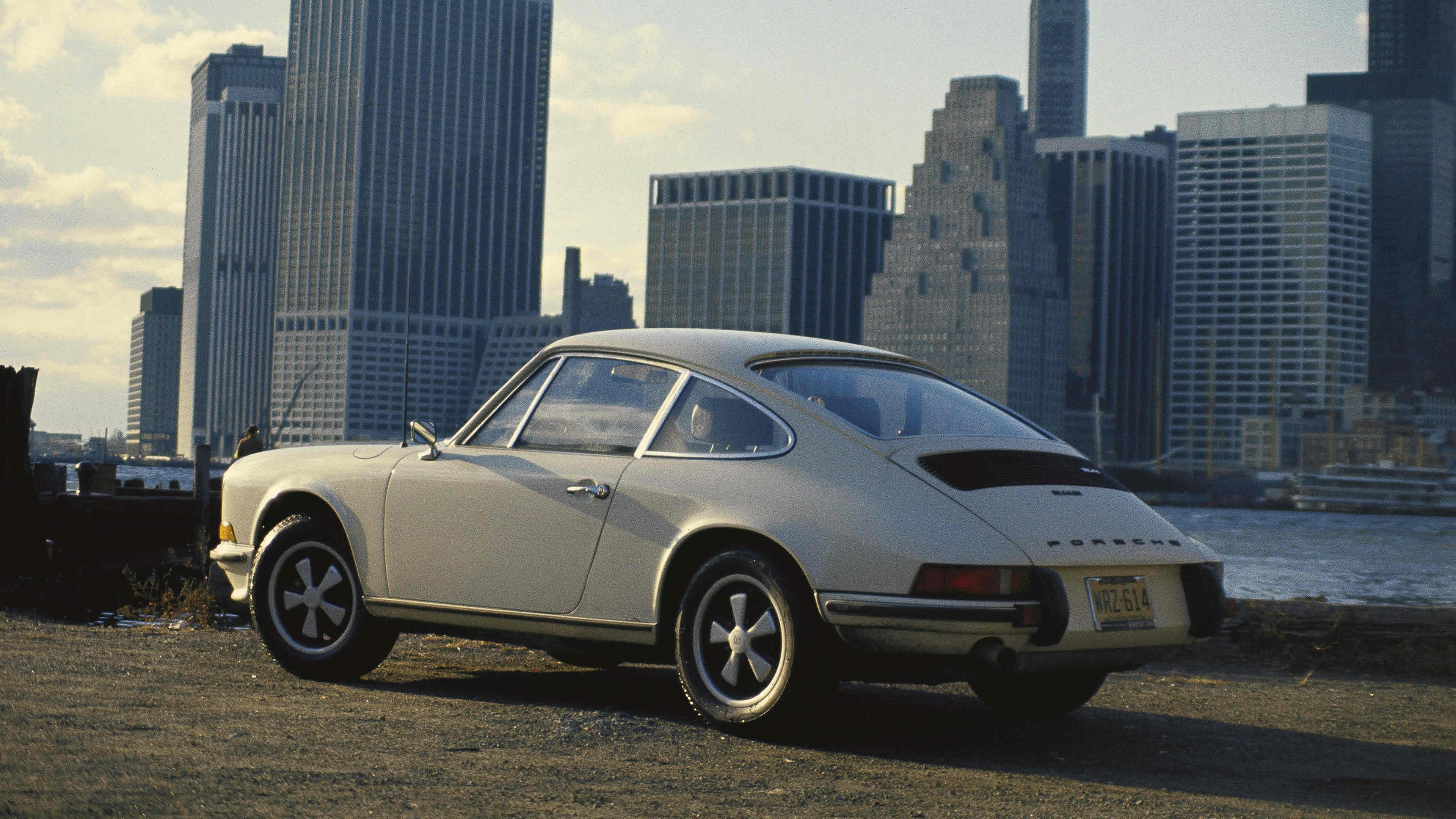 Silver Porsche 911 S 2.4 Targa (1972–73) against the backdrop of a city.