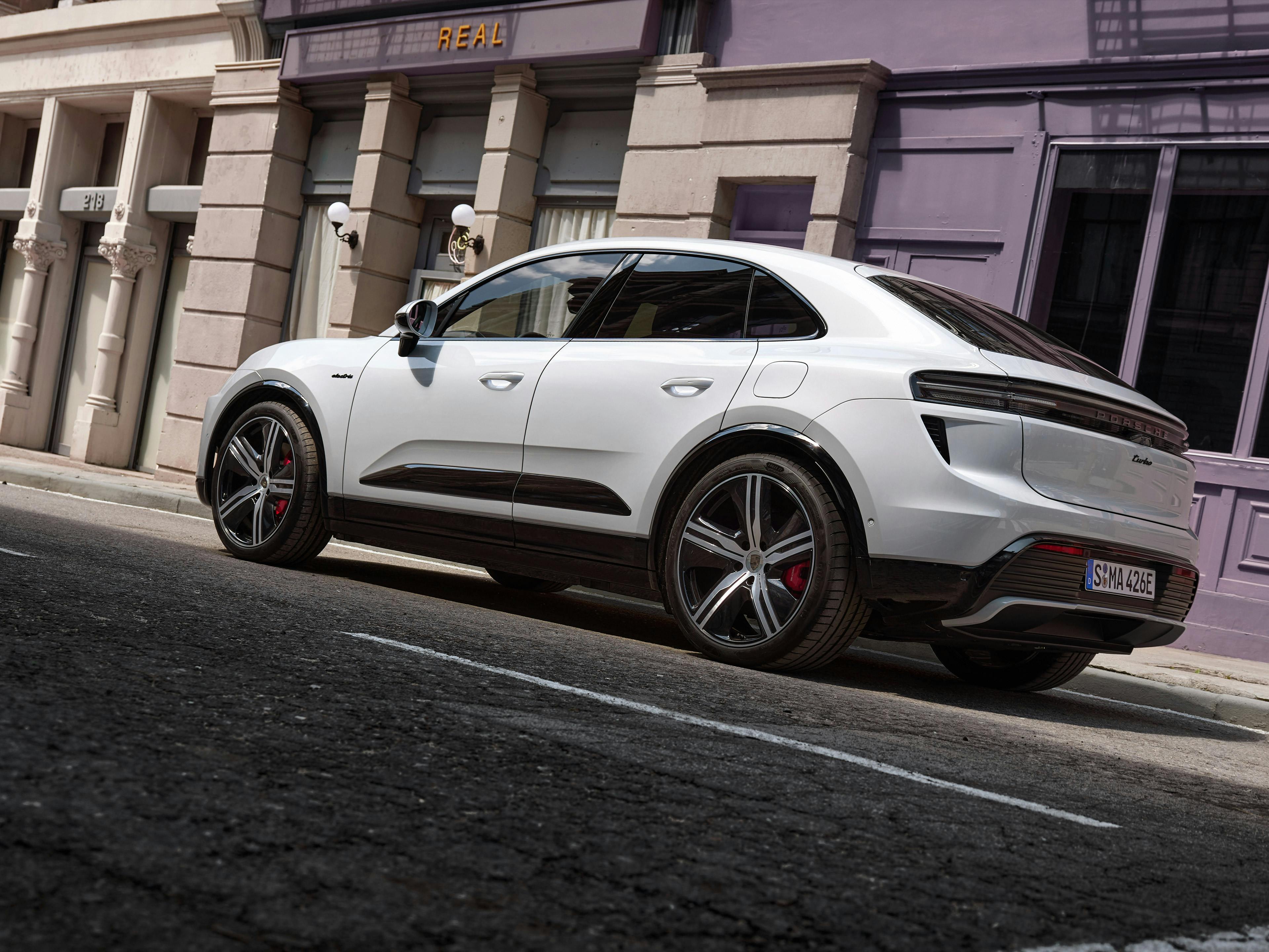 White Porsche Macan electric parked in an urban environment.