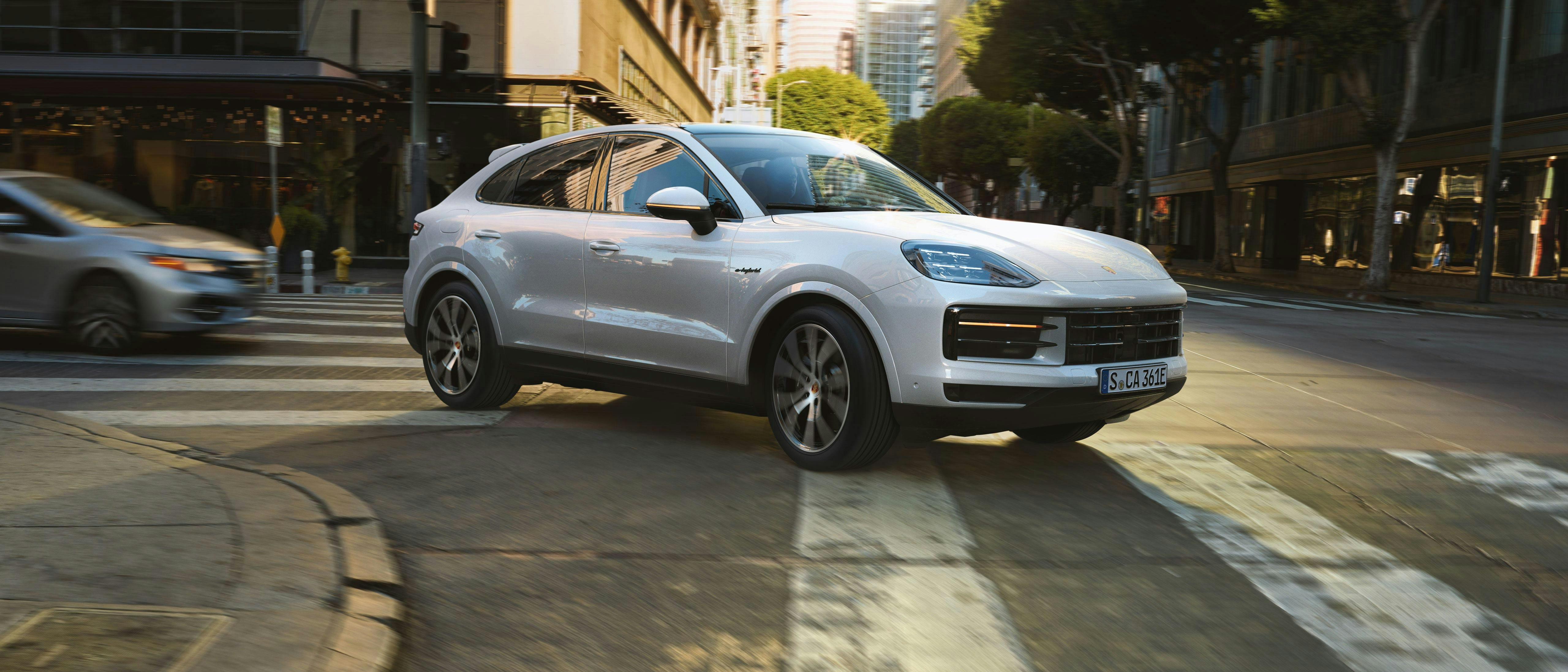 White Porsche turning in urban environment