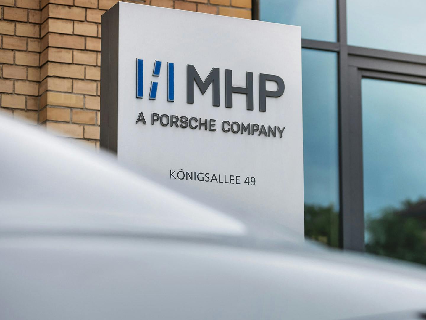 Main entrance with MHP company sign in front of the entrance.