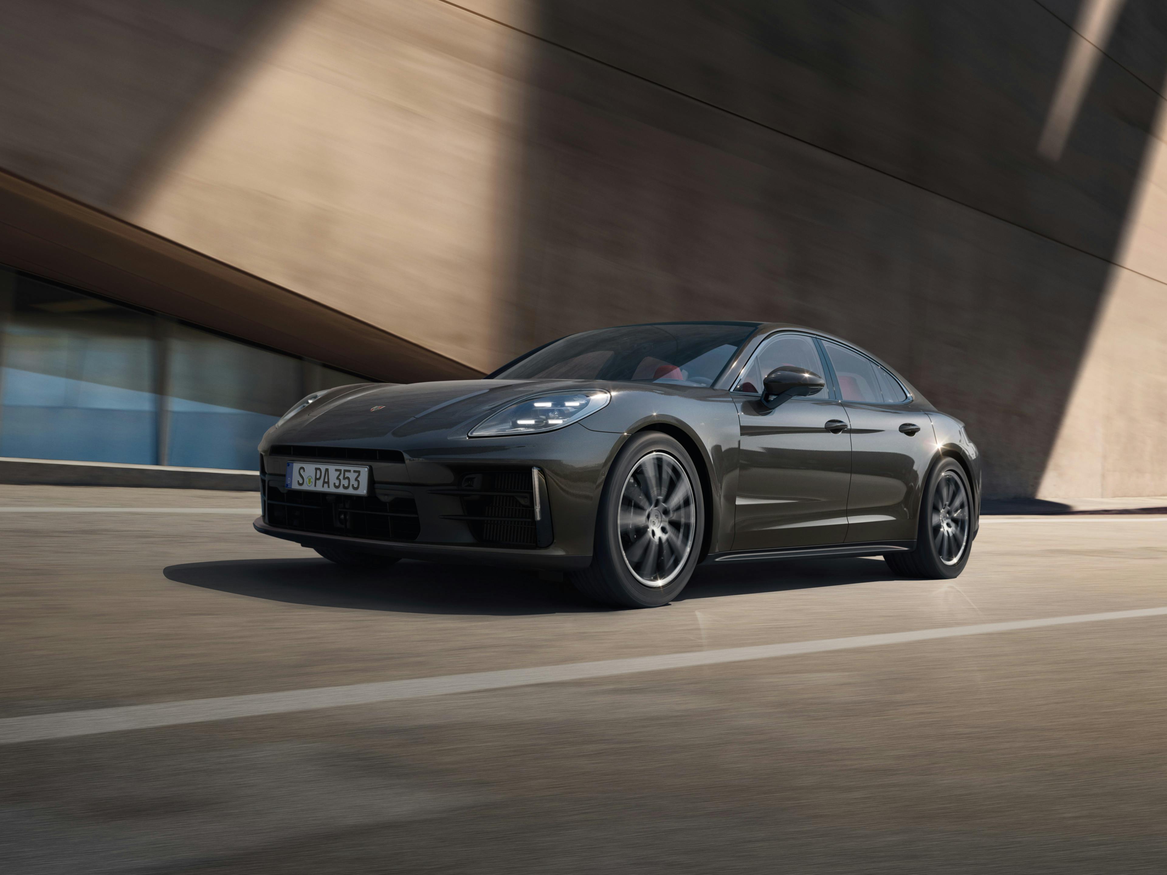 A black Panamera 4 driving on a street.