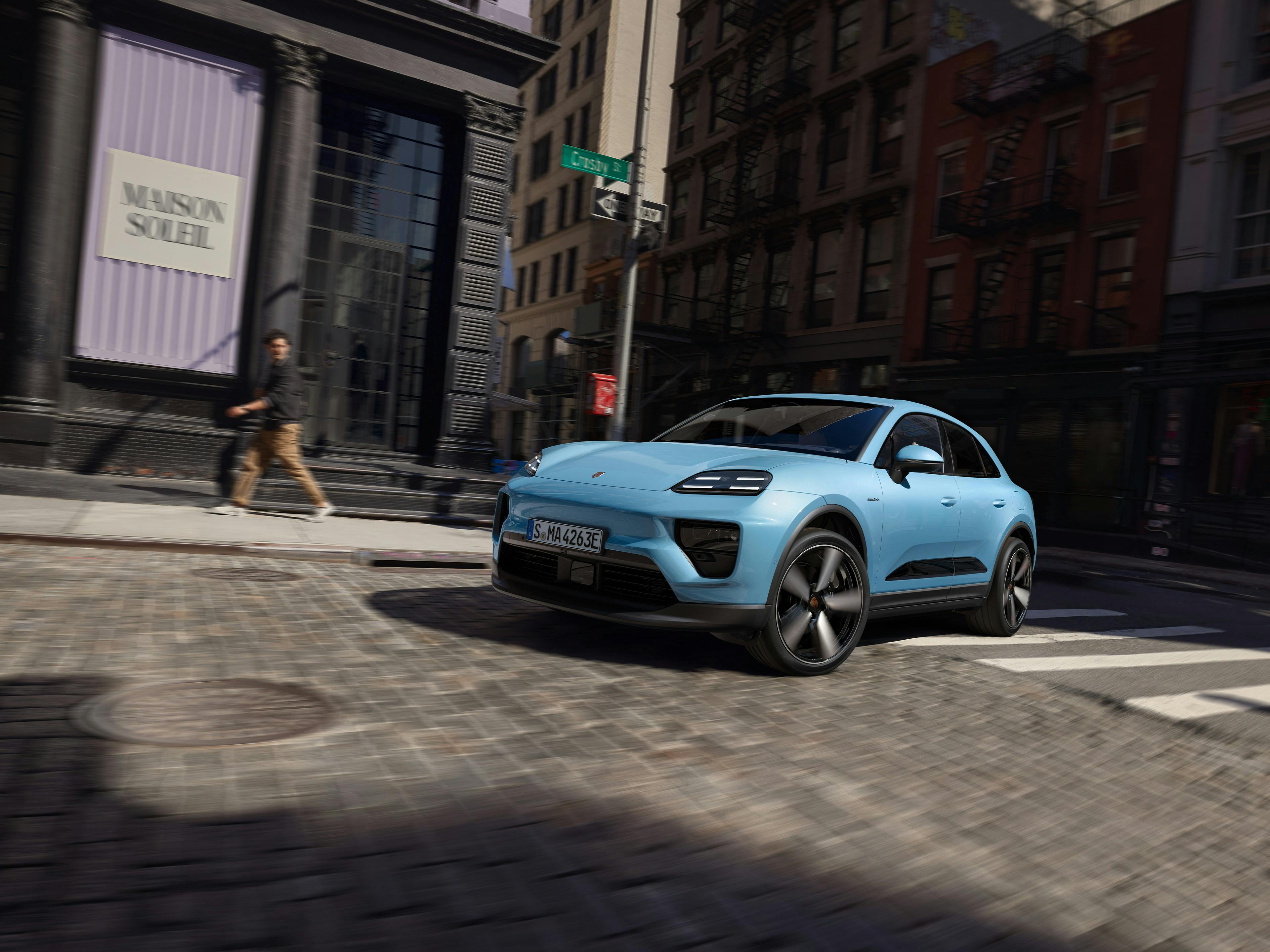 Macan Electric driving through the city.