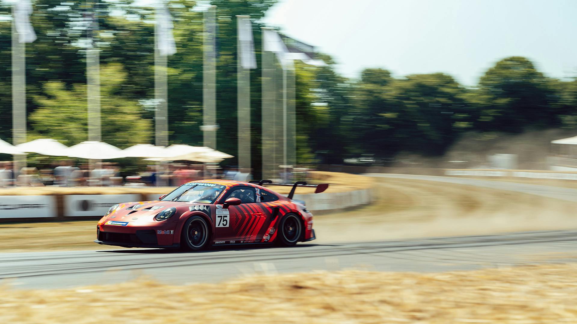 Porsche 911 GT3 cornering on the Goodwood hillclimb.
