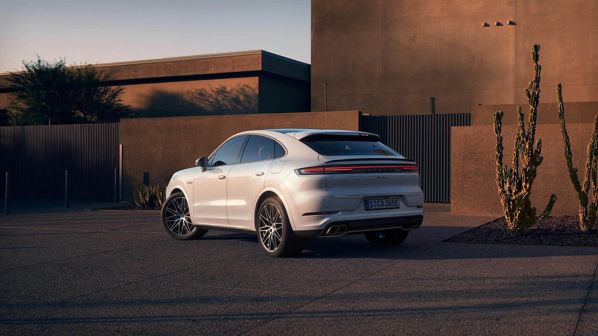 A Porsche Cayenne Turbo E-Hybrid with GT package in the sun in a multi-storey car park.