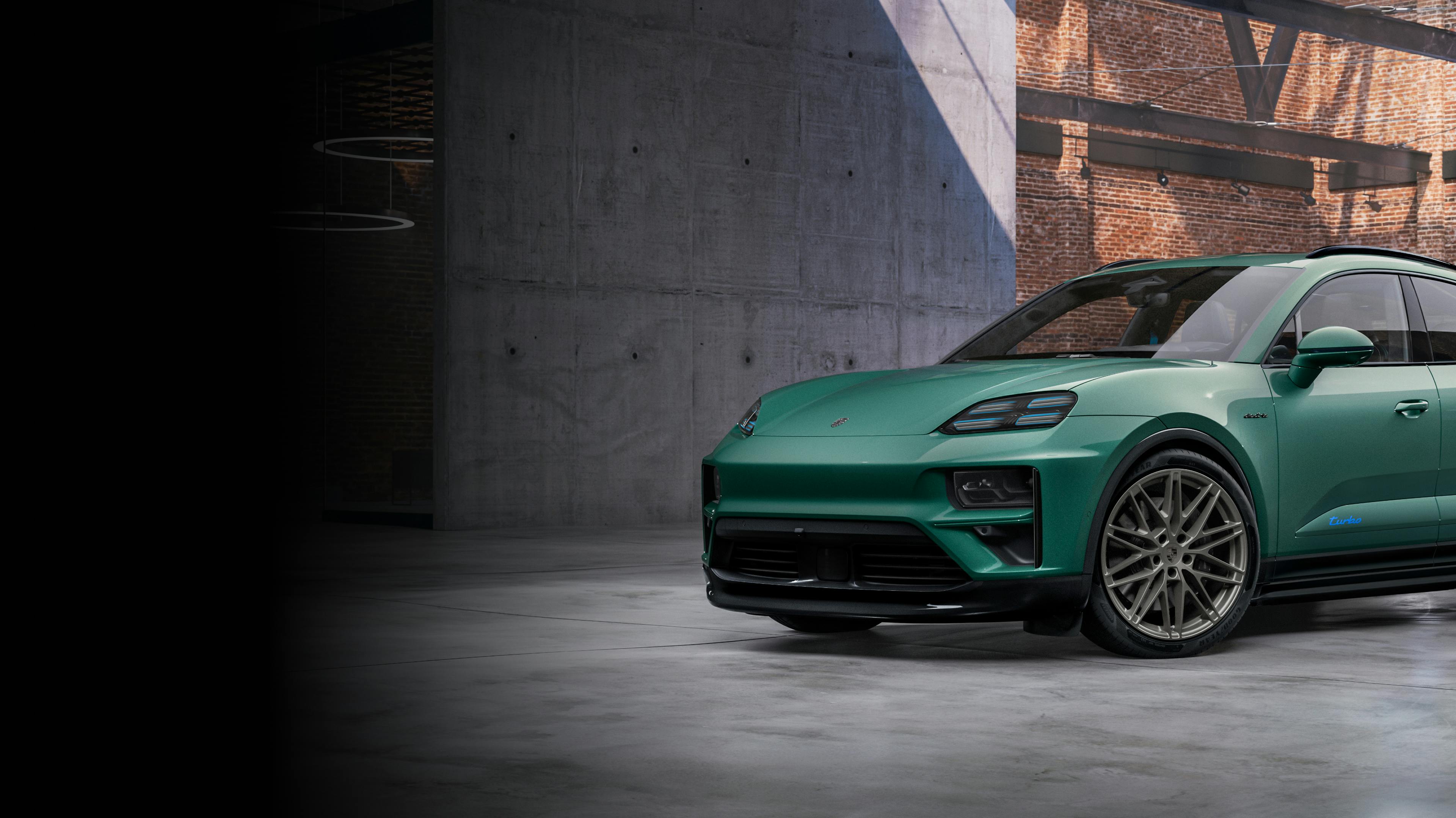 Porsche Exclusive Manufaktur Macan Turbo painted in Emerald Green Metallic in a hall. Side view.