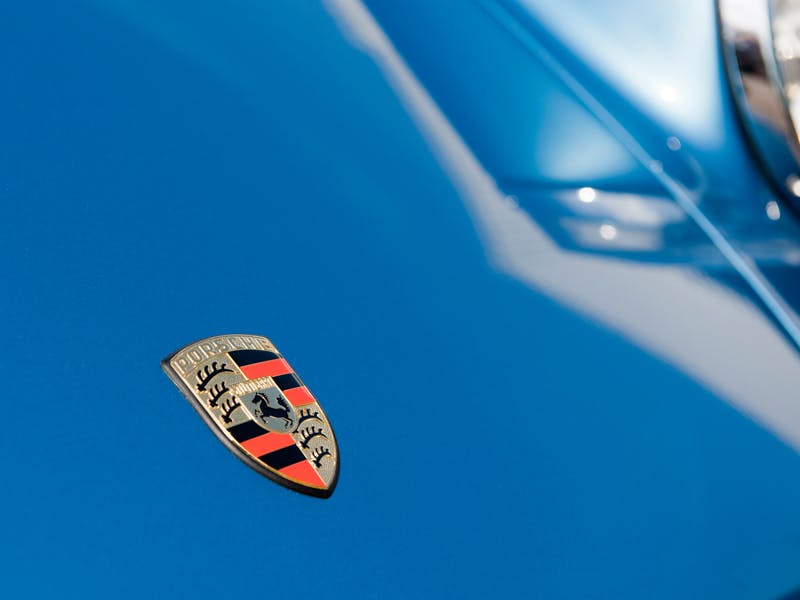 Detail: Porsche Crest on a Blue Porsche