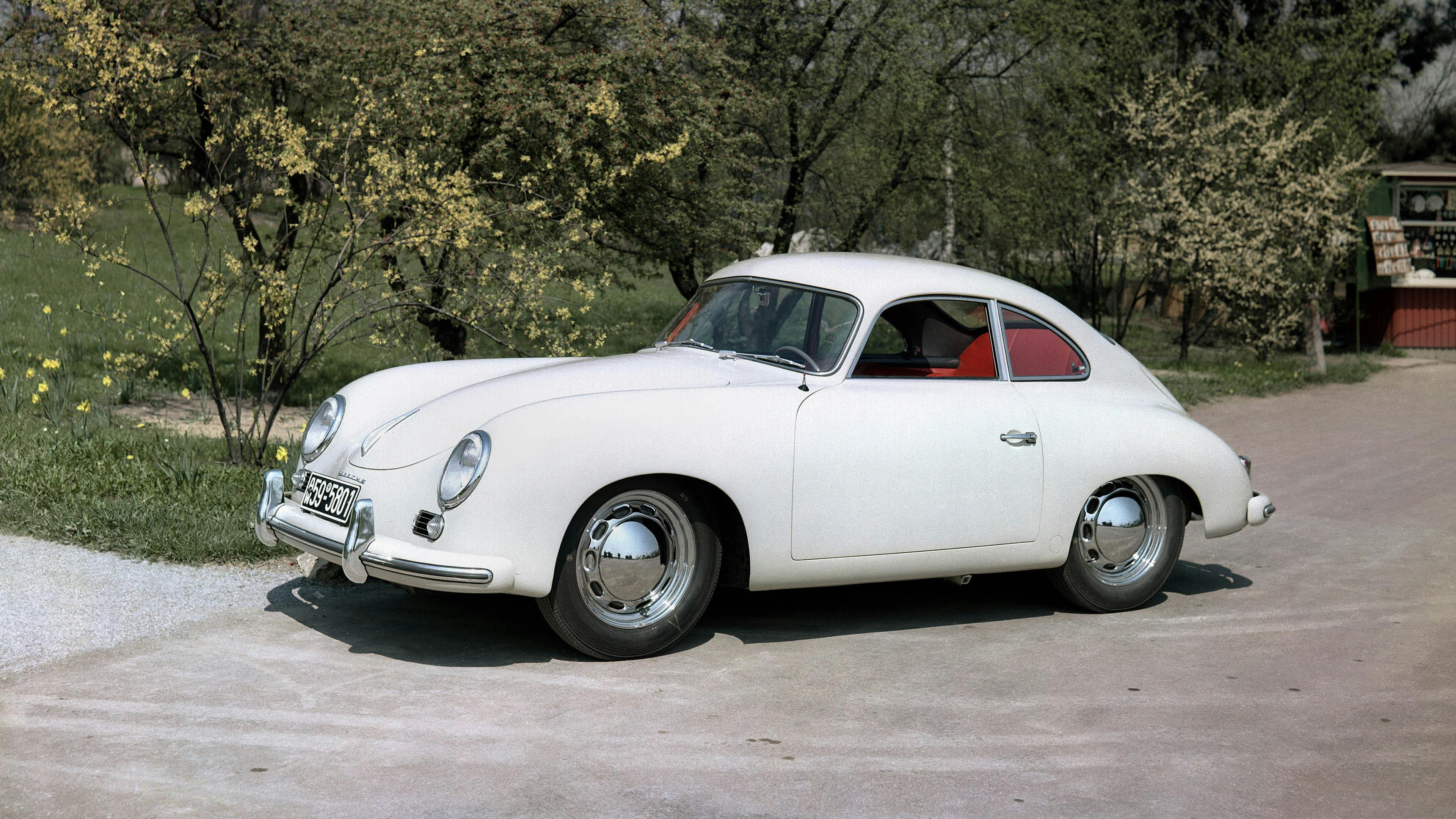 Photo of a White Porsche 356 1500 Super in the countryside.