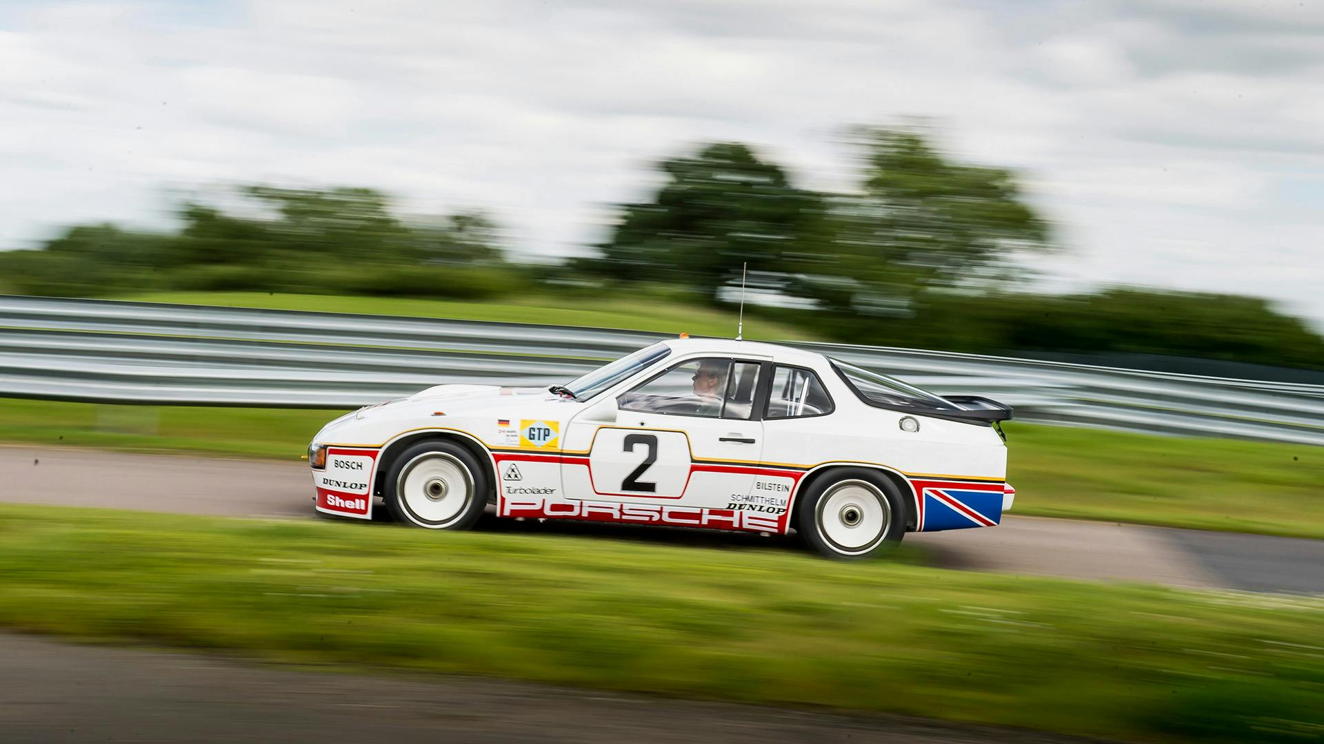 Fully restored Porsche 924 GTP driving on the race track.