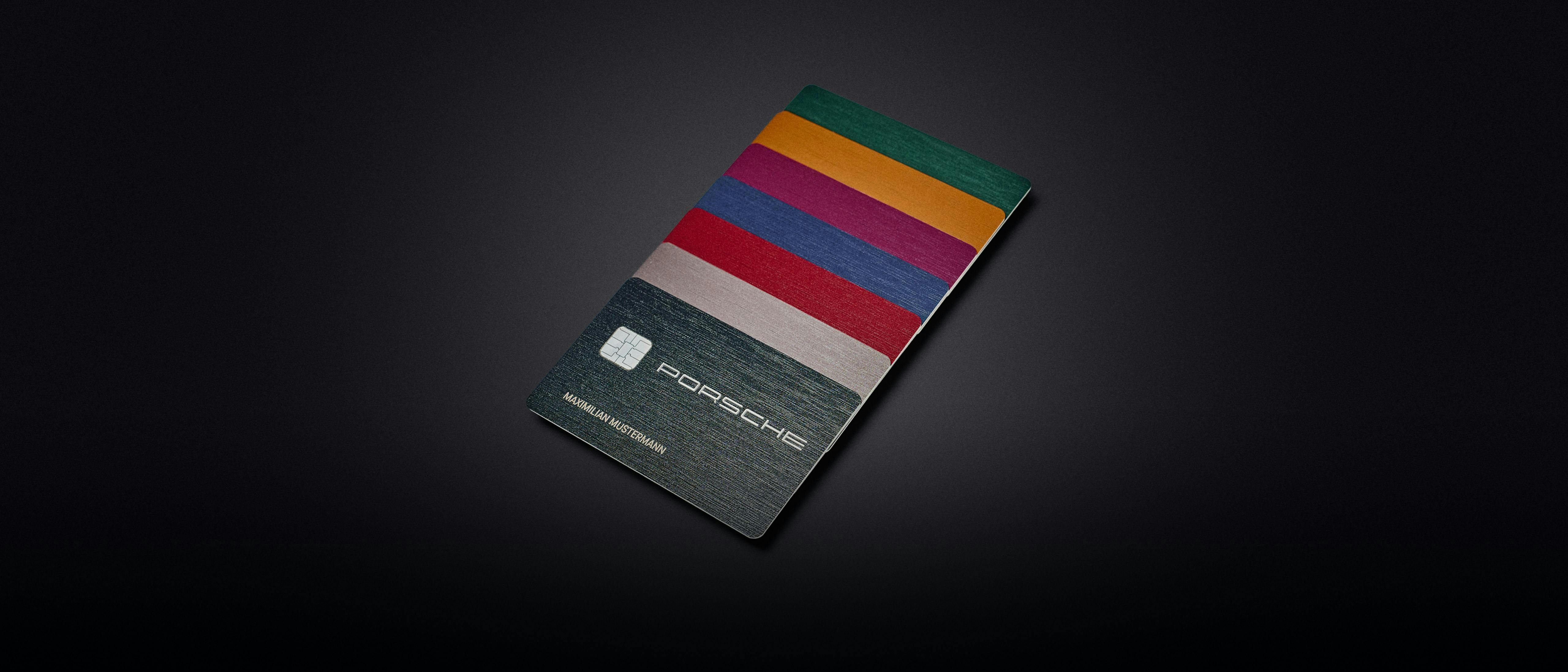 Seven colourful Porsche credit cards are arranged in a fan shape in Porsche colours.
