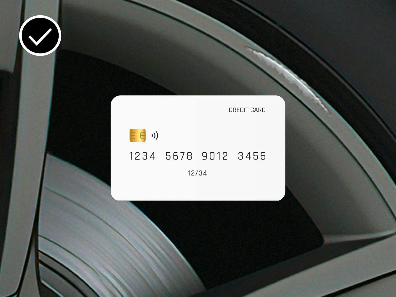 Credit card on a smooth black wheel with a checkmark, indicating acceptable scratches.