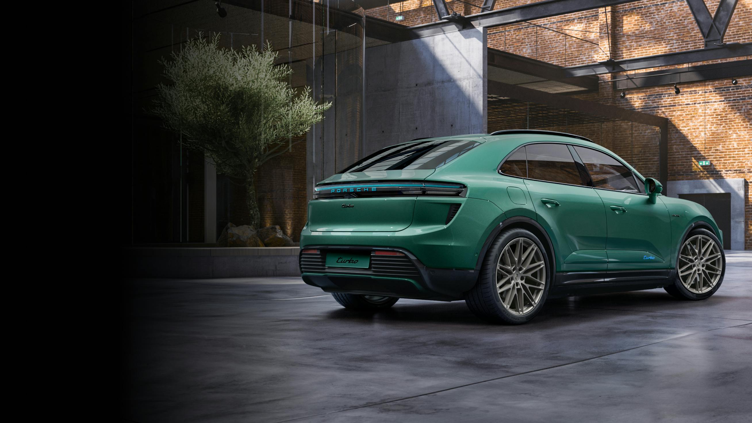 View of the rear of the Porsche Exclusive Manufaktur Macan Turbo in Emerald Green Metallic.