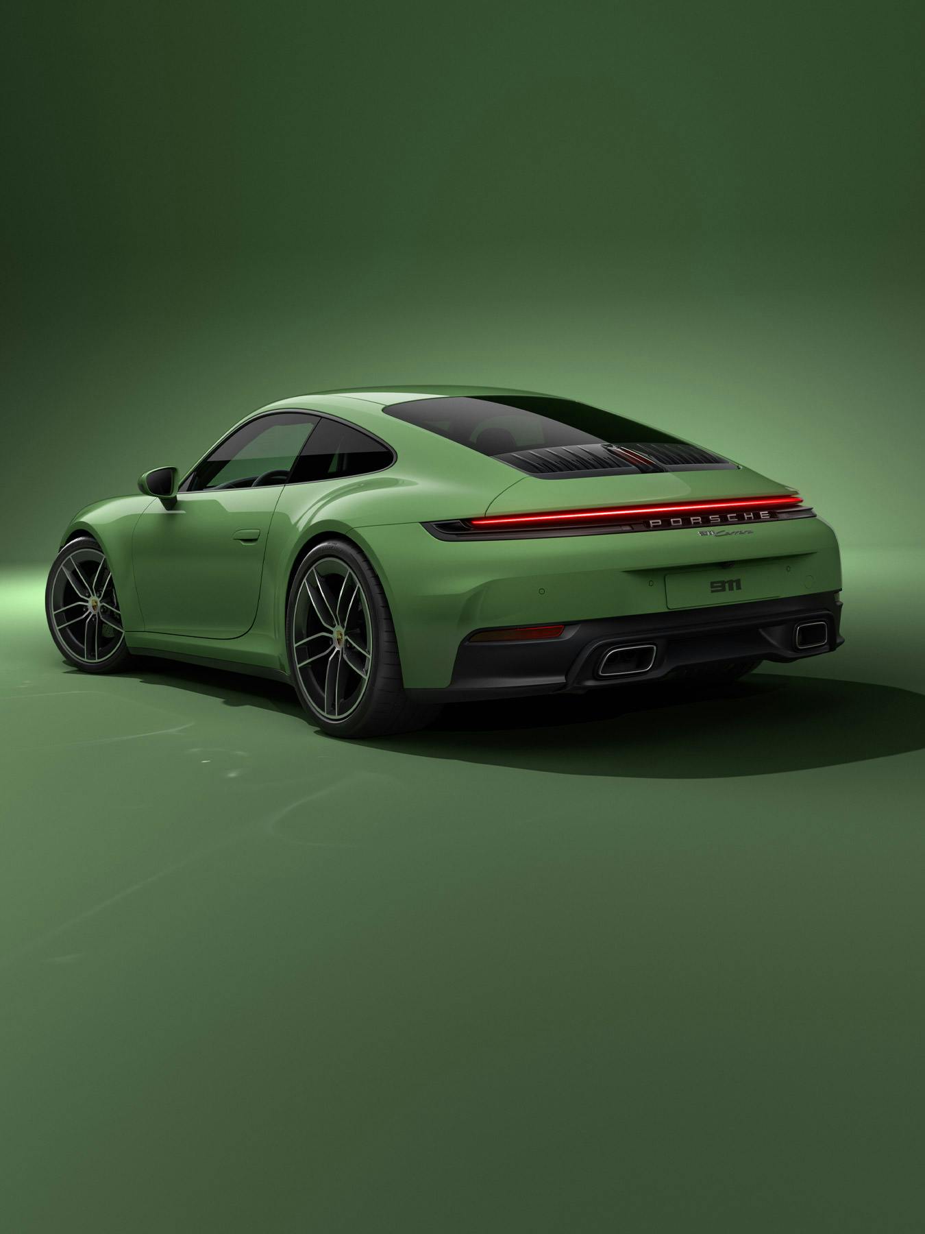A rear studio shot of a light green Porsche 911.