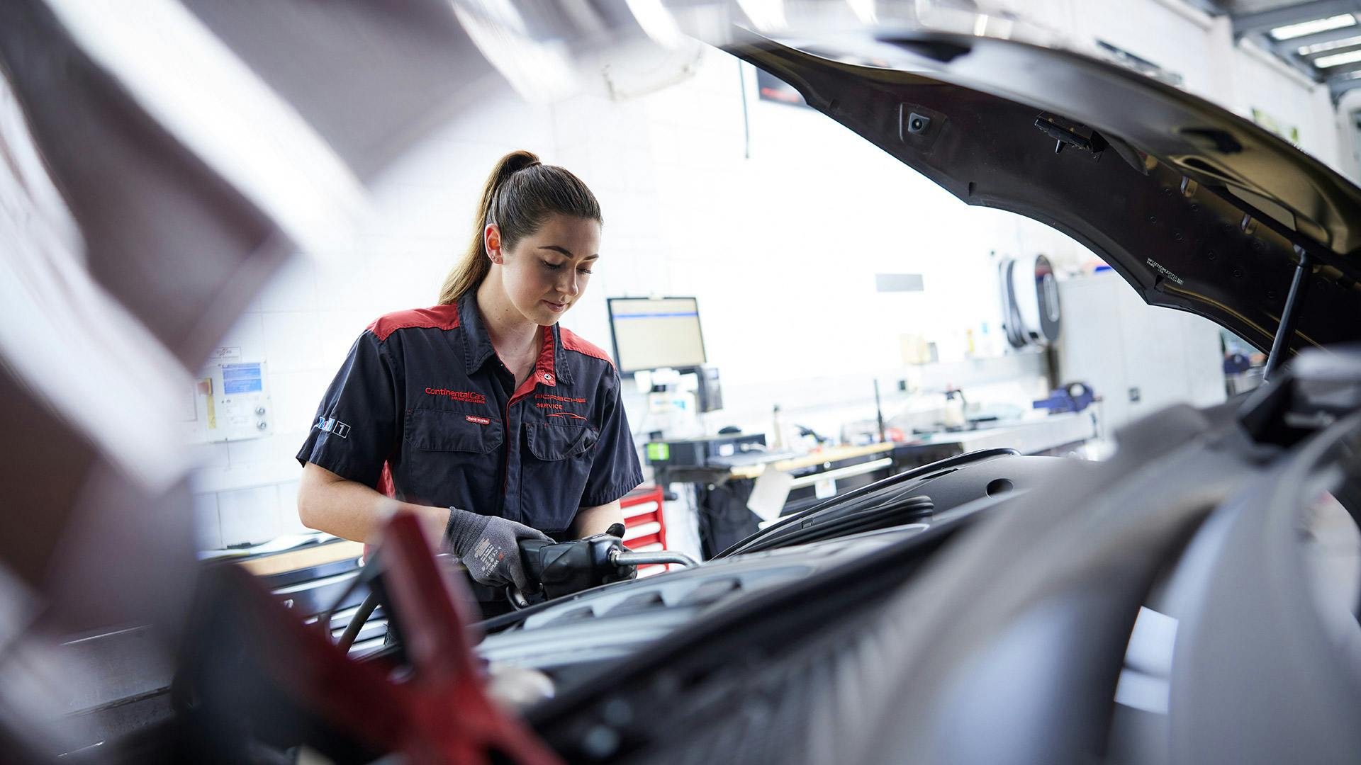 Porsche technician working on vehicle