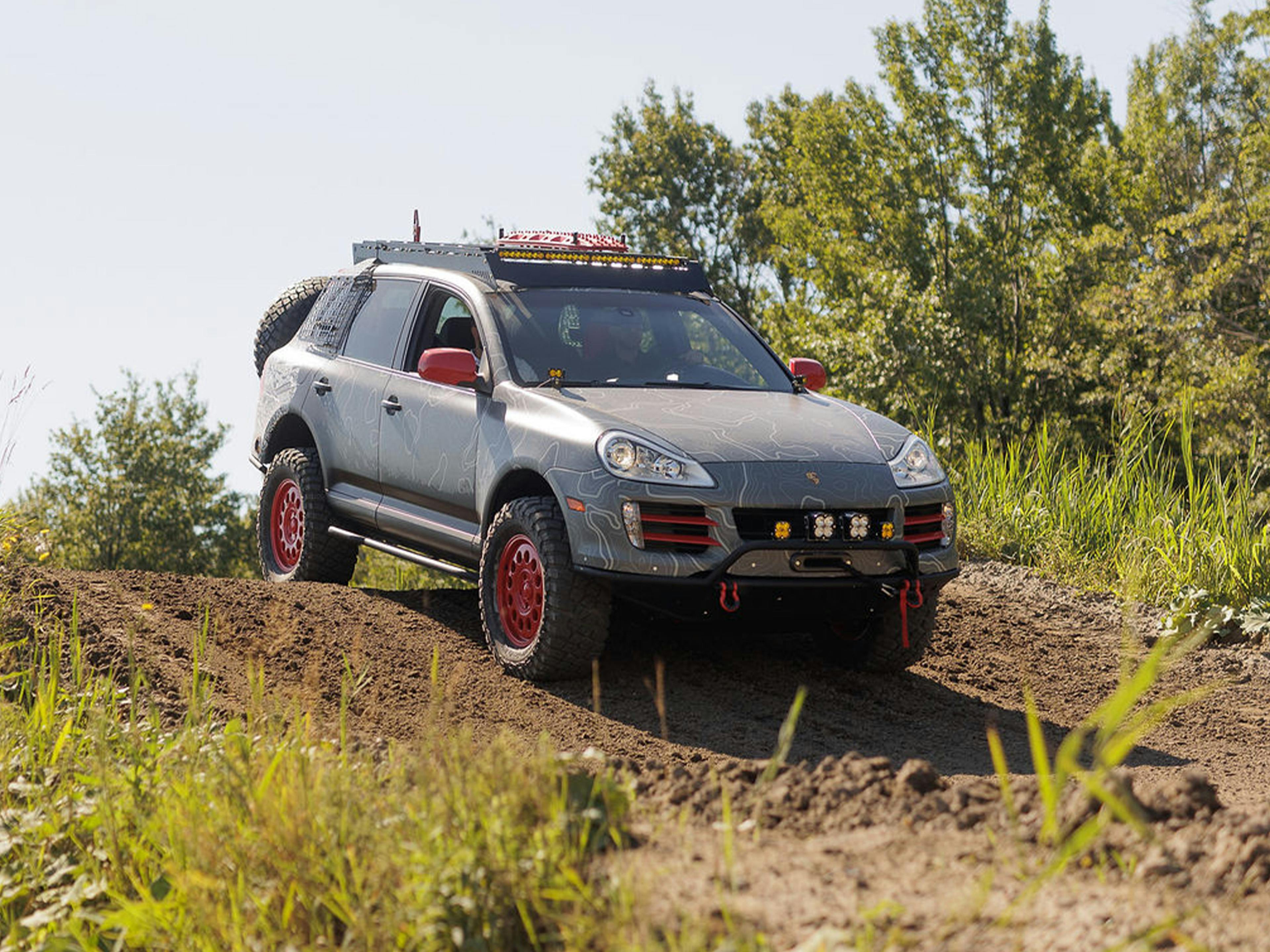 Lauzon – A silver Porsche Cayenne showcased inside a service bay with tilted flooring.