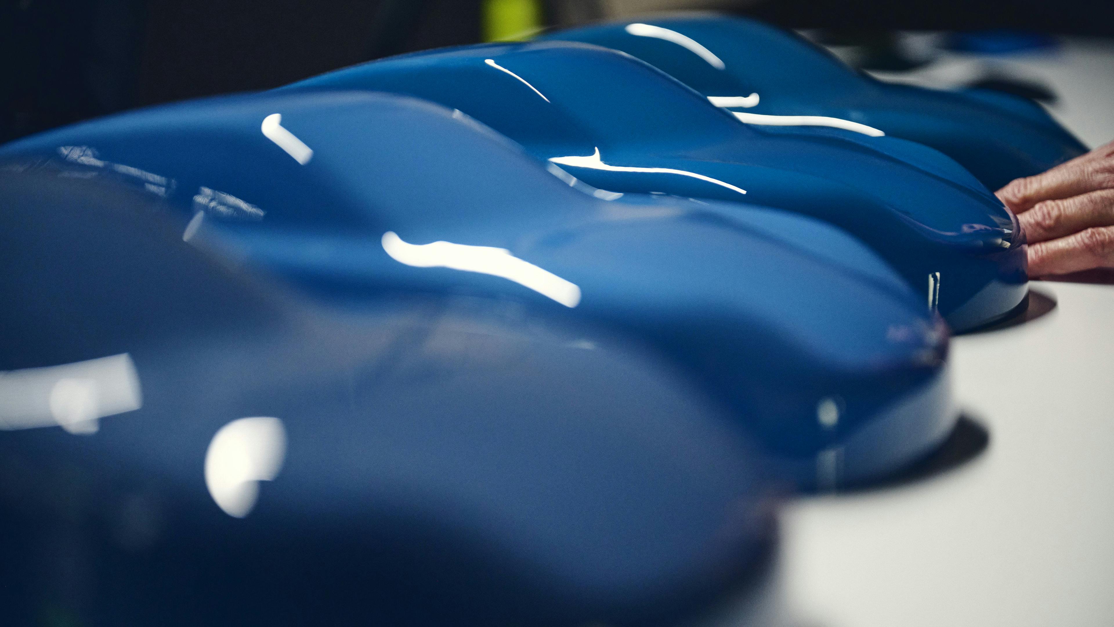 Various blue colours on small car shapes in a close-up.