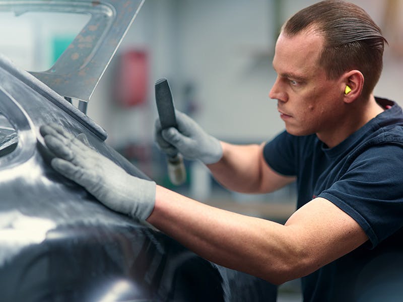 Mechanic working on a Porsche bodyshell.