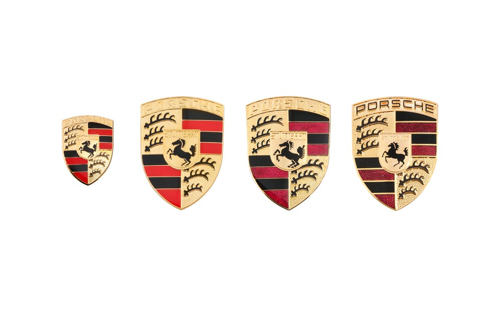 Four images of different Porsche Crests.