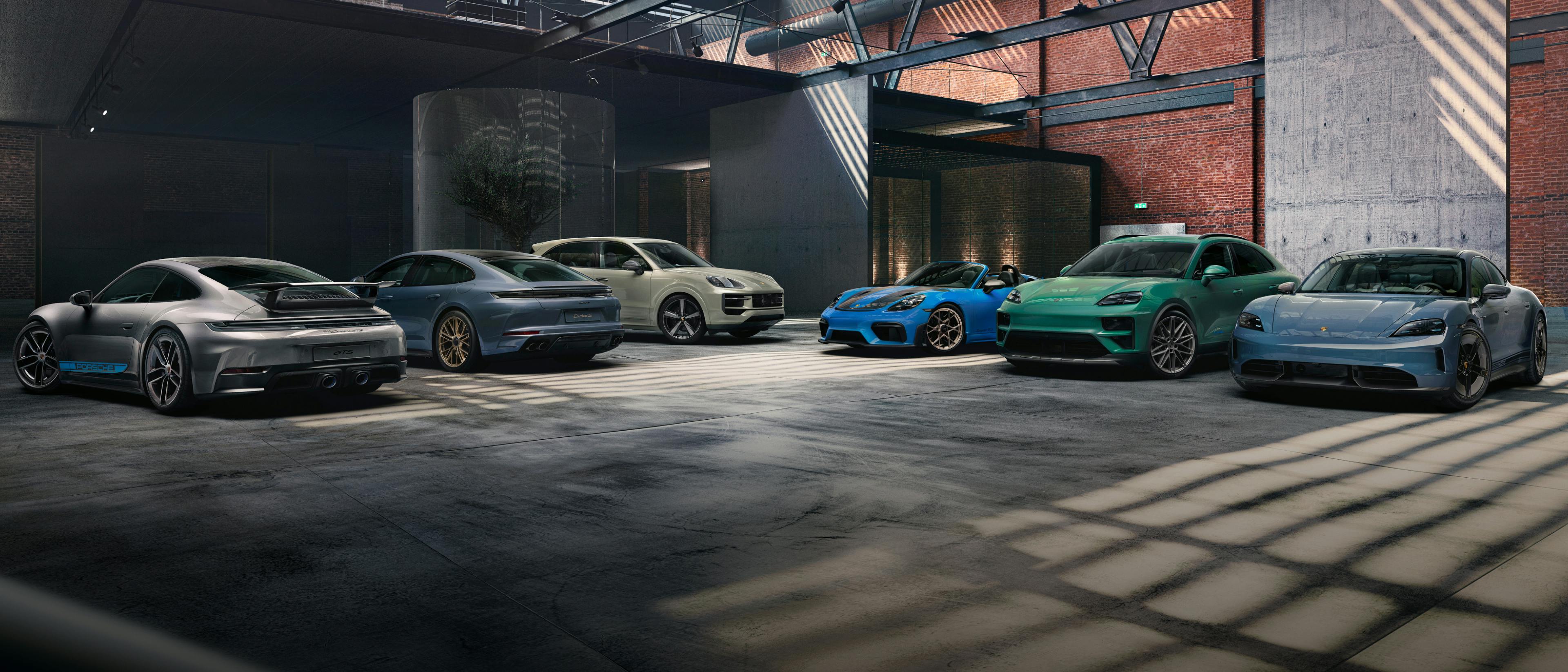 Various Porsche models next to each other in a warehouse.