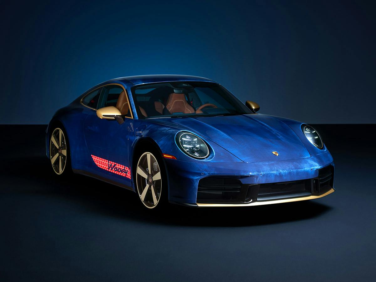Porsche 911 Carrera T “Woody”, front three-quarter view in Dark Sea Blue with a unique denim-inspired patina and accents in Aurum and Coffee Black.​