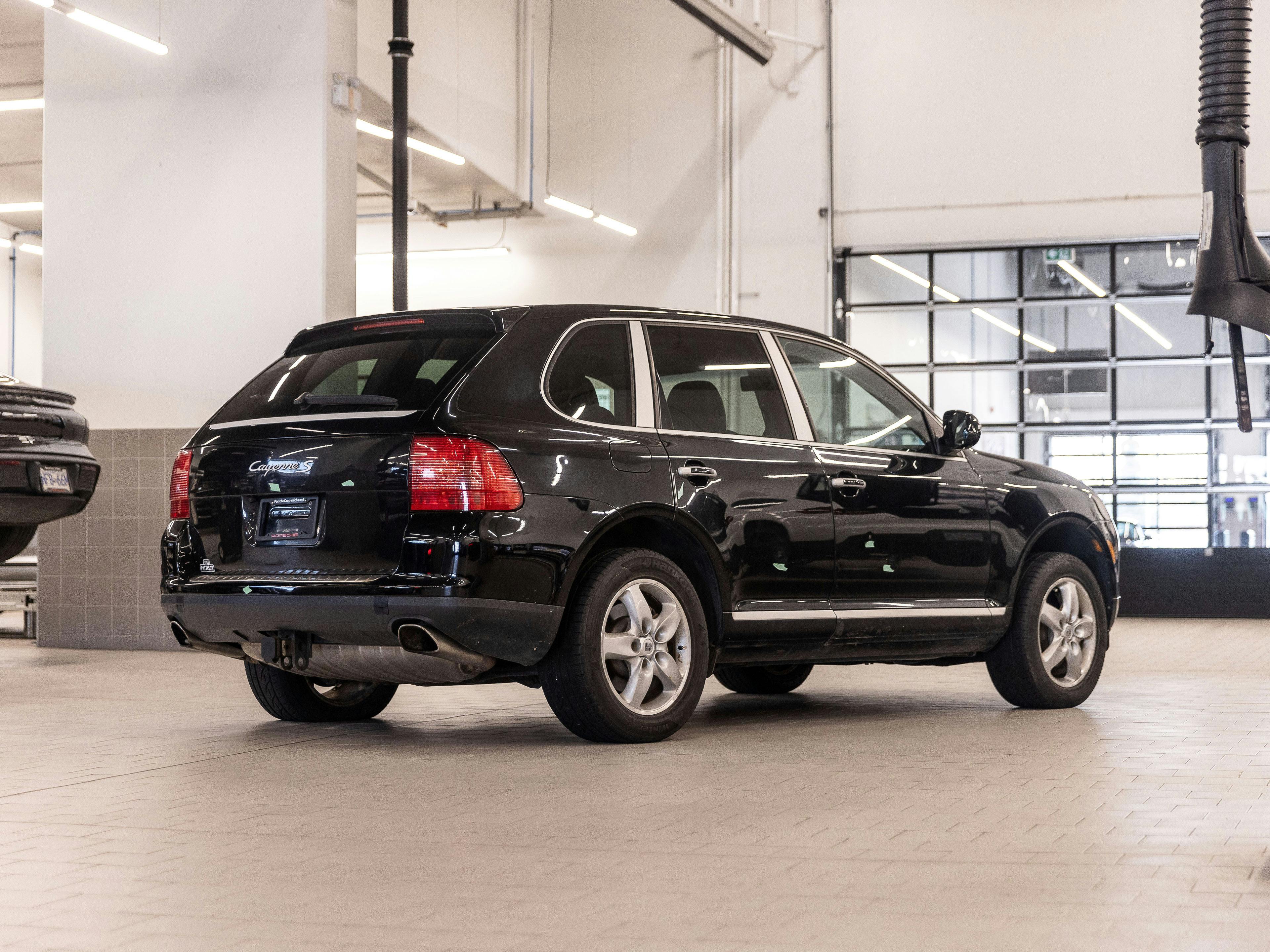Richmond – A black Porsche Cayenne shown in a bright and spacious service bay.