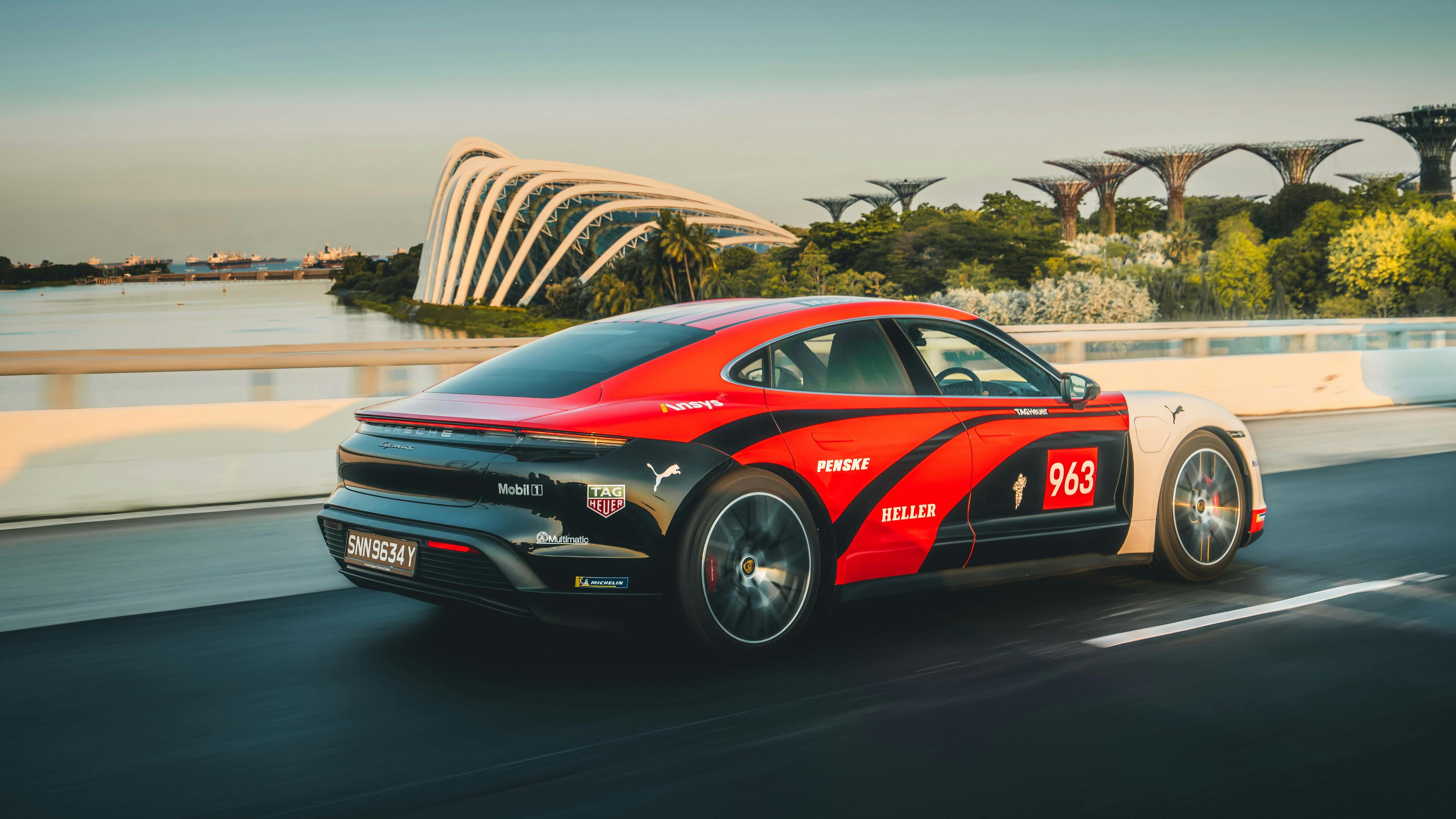 Black, Red, White 963 Livery Taycan with Gardens By the Bay’s supertrees in the background