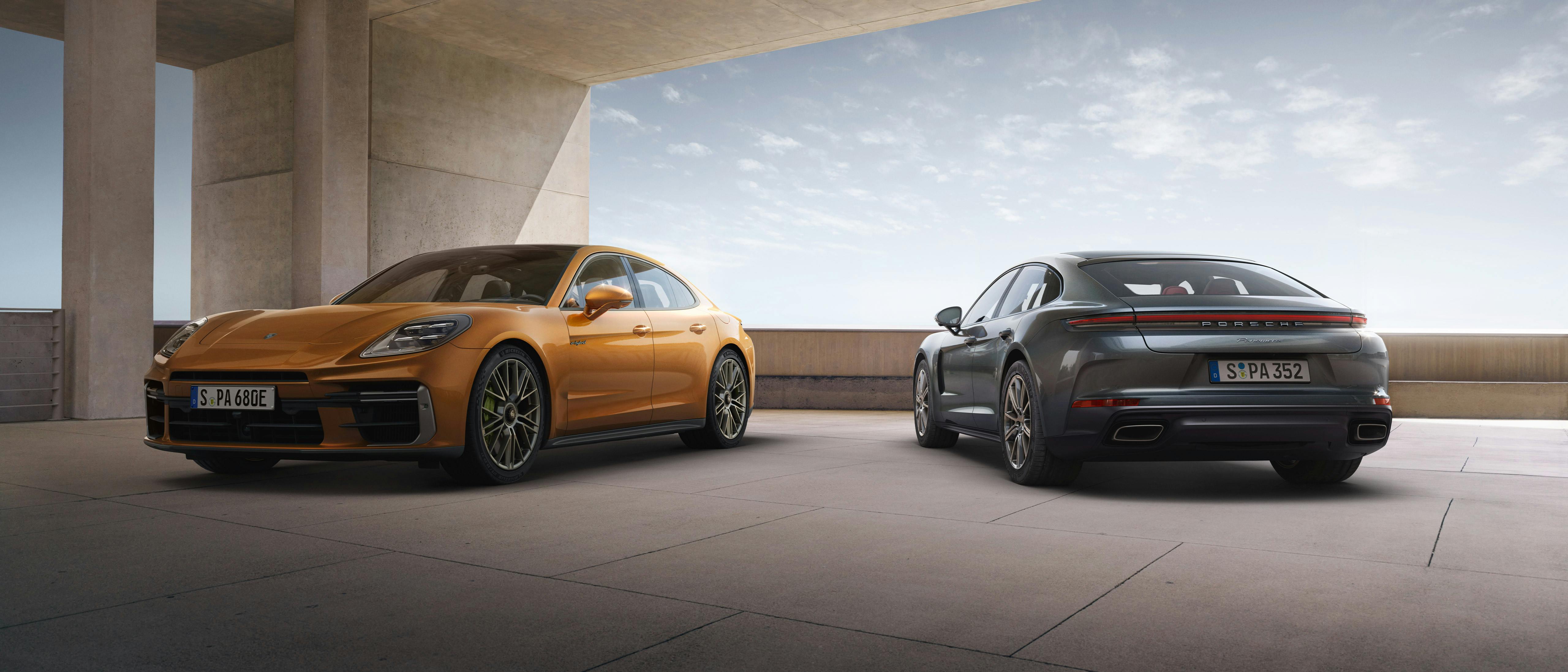 The Panamera and the Panamera Turbo E-Hybrid parked beside each other in a modern open space.