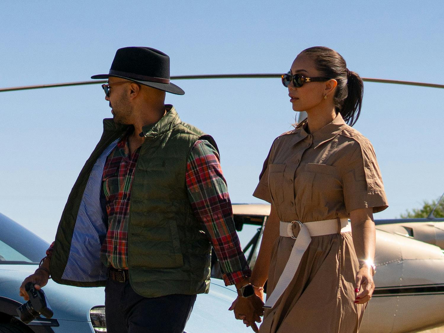 Pia Muehlenbeck and Kane Vato holding hands while walking fashionably