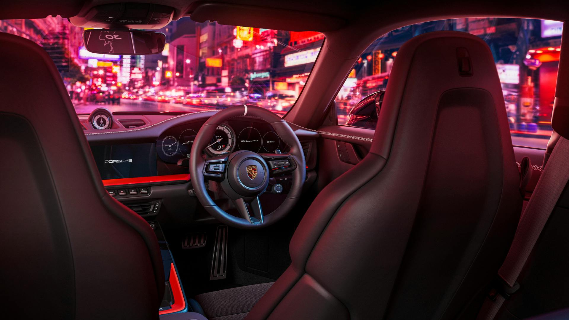 Dreams in Colours: Interior close-up with a steering wheel und pink lights outside.
