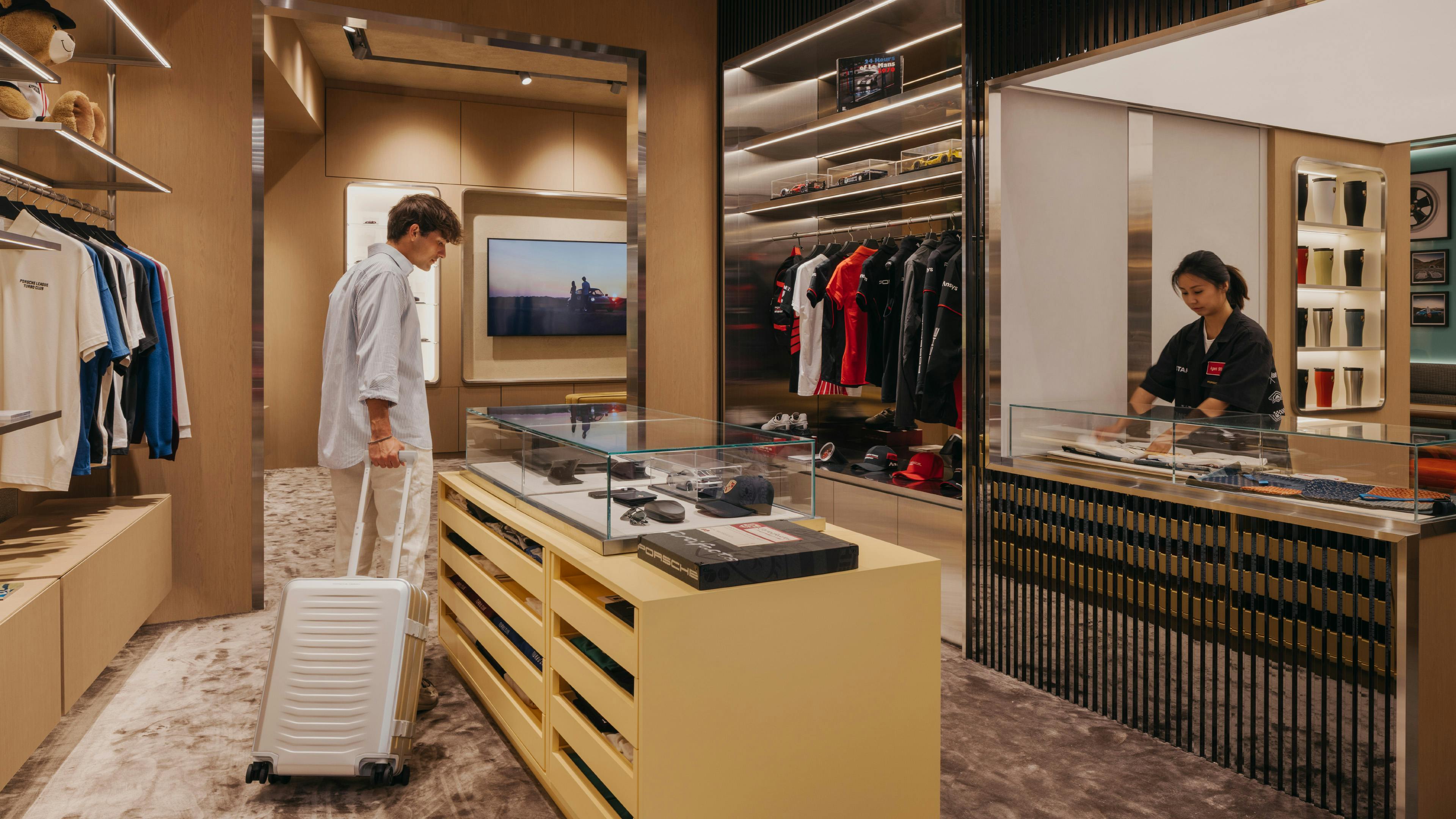Traveller with Porsche luggage in the Porsche at Jewel store exploring products