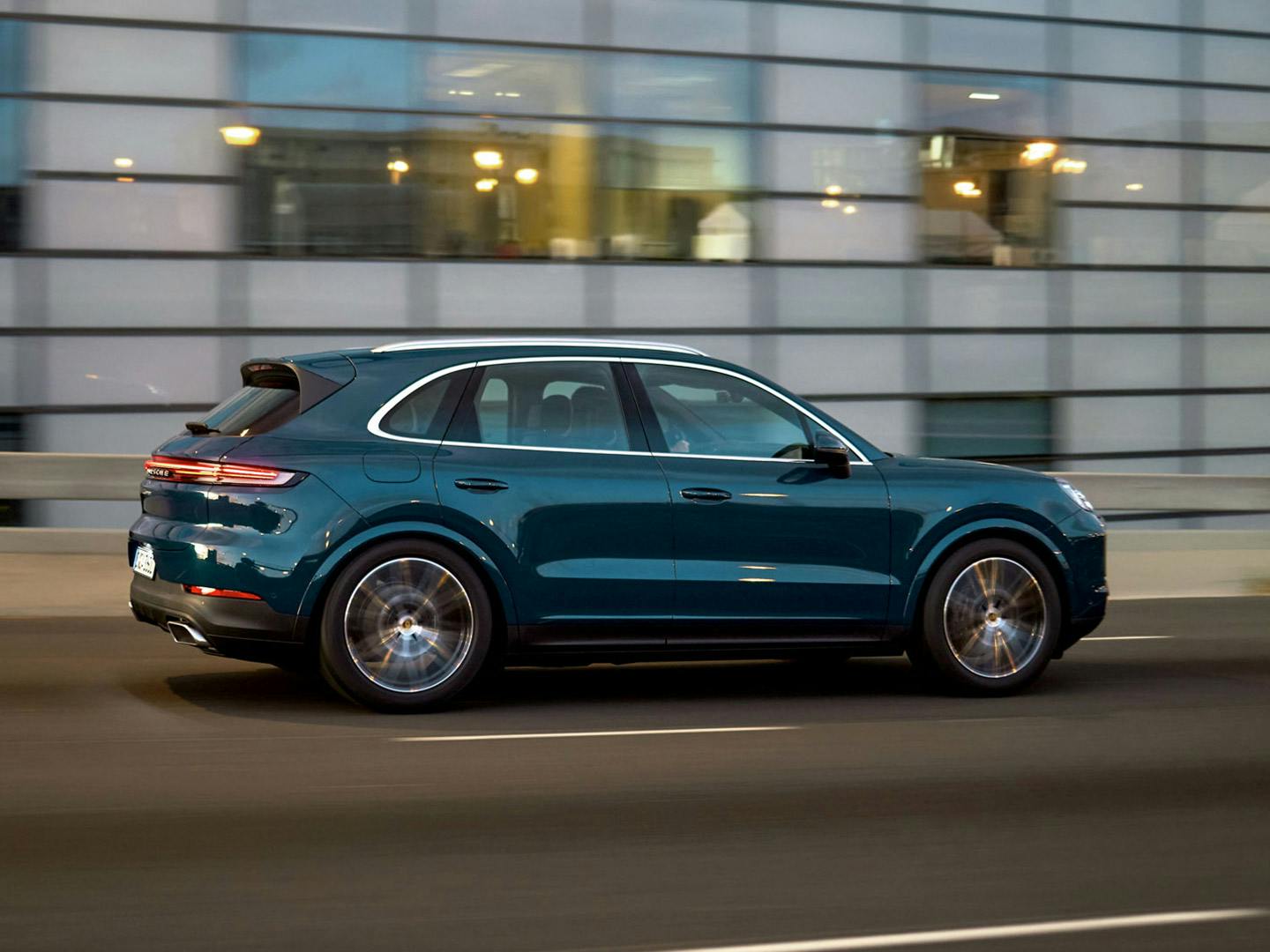 Blue Cayenne driving along highway