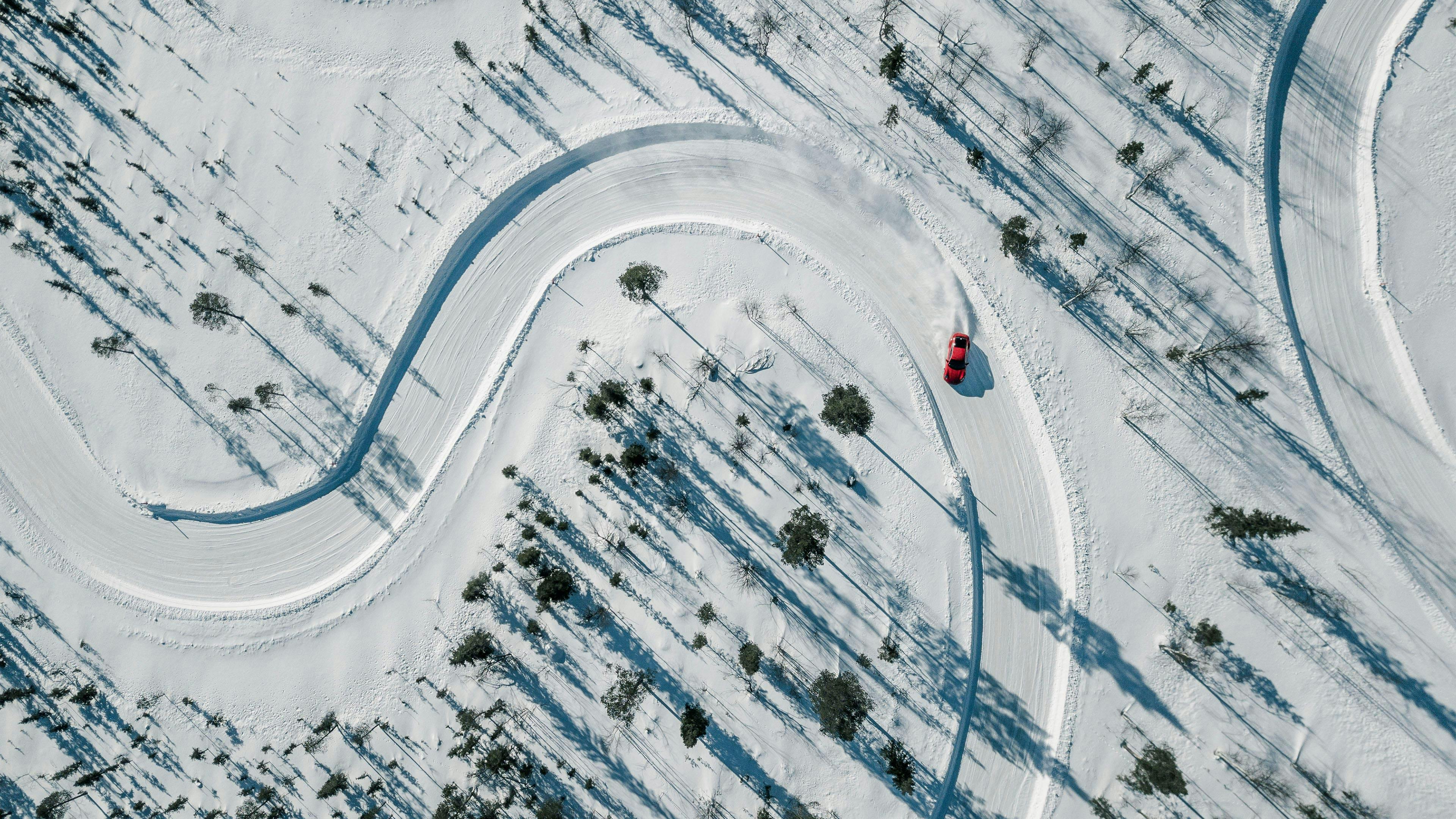 A Porsche drifts through a bend in the unspoilt snowy landscape of Levi during the Ice Experience in Finland.