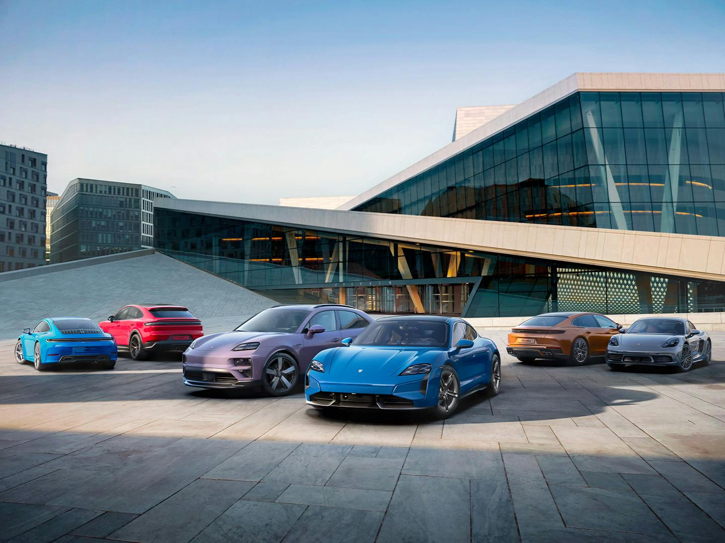Image featuring a full model range in the parking lot of a modern building.