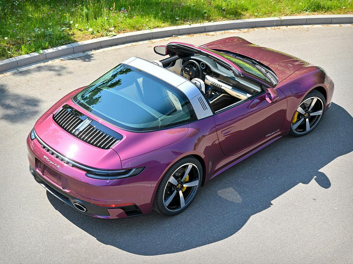 A 911 Targa 4S in individual colour Magic Magenta Chromaflair with Cabriolet open.