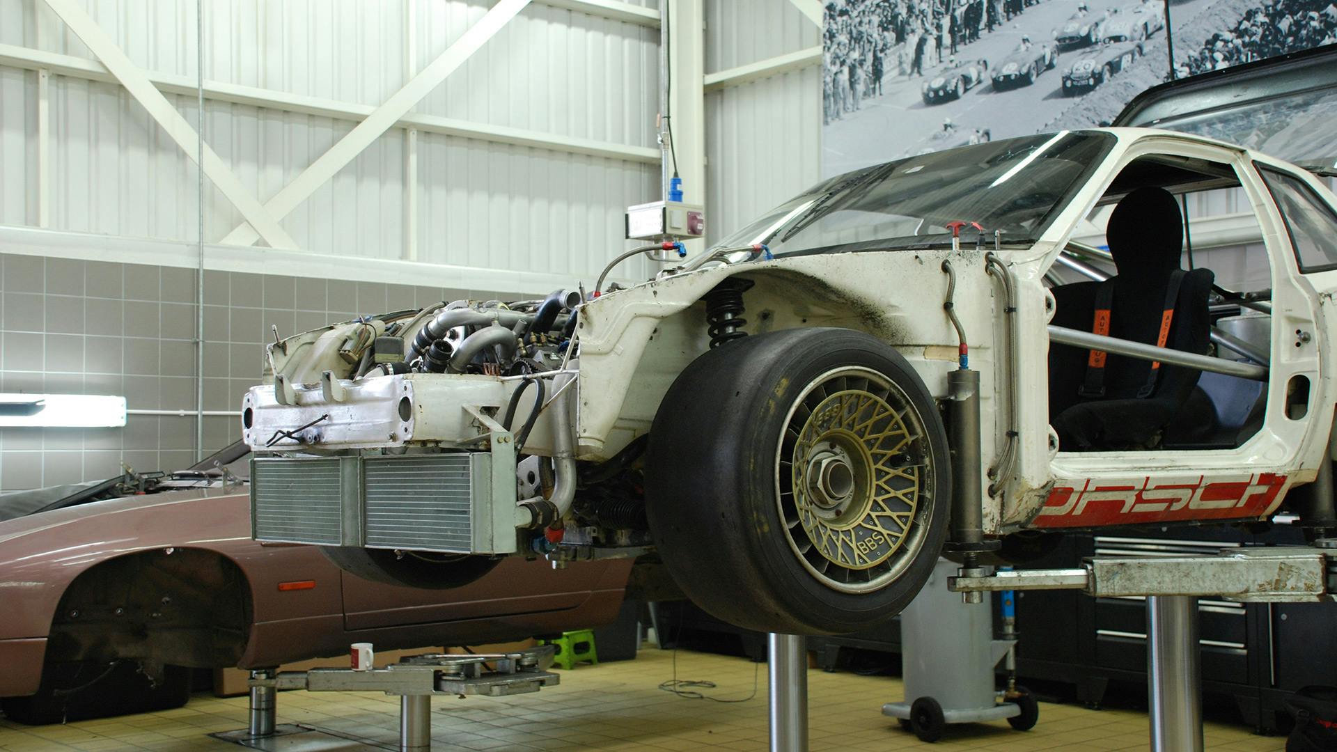 Dismantled Porsche 924 GTP standing on a lifting platform.