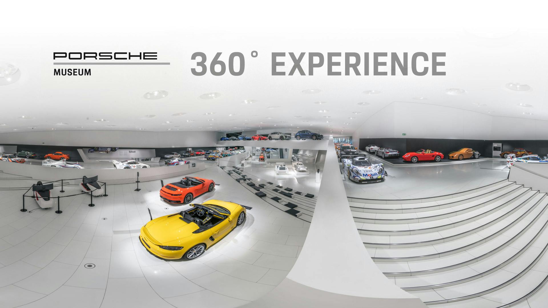Excerpt from the Porsche museum exhibition. The lettering "360° Experience" is emblazoned above the vehicles.